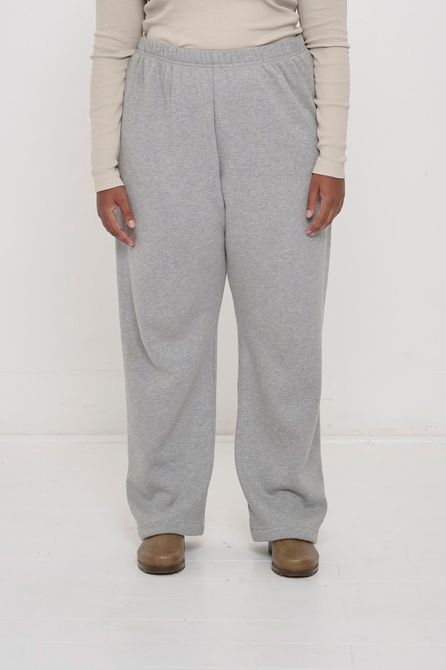 Front view: 5'8" person sized up in size 2XL Heather Sweatpants, worn high on the waist with a relaxed fit.