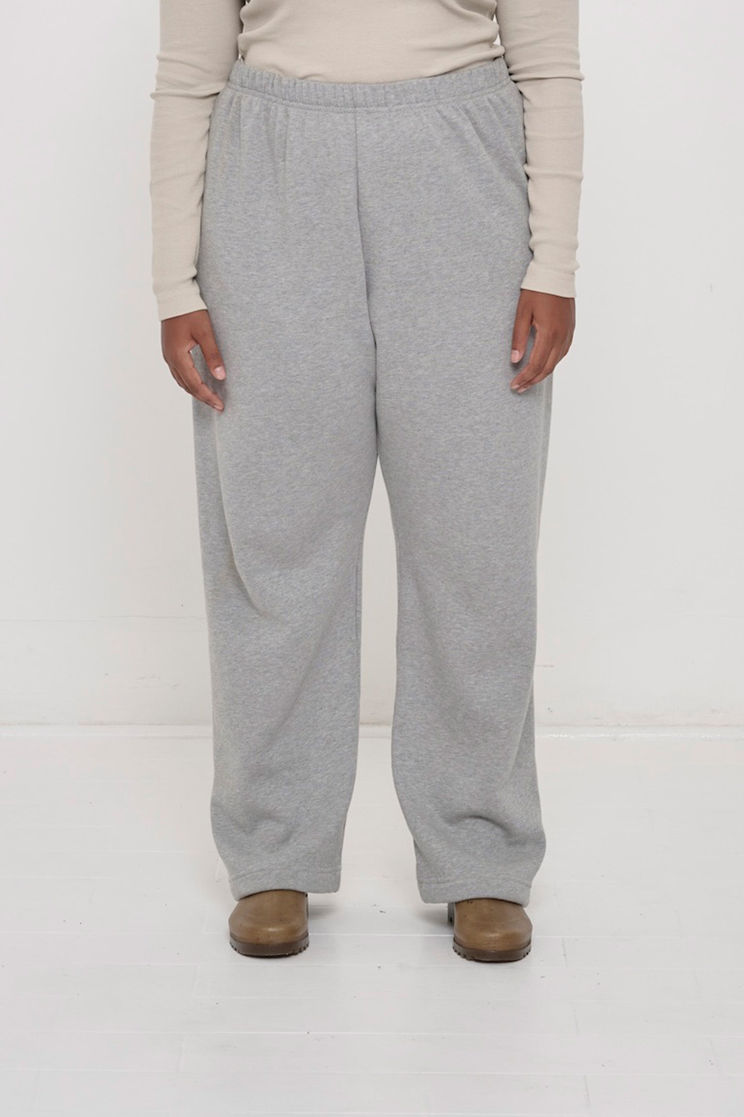 Front view: 5'8" person sized up in size 2XL Heather Sweatpants, worn high on the waist with a relaxed fit.