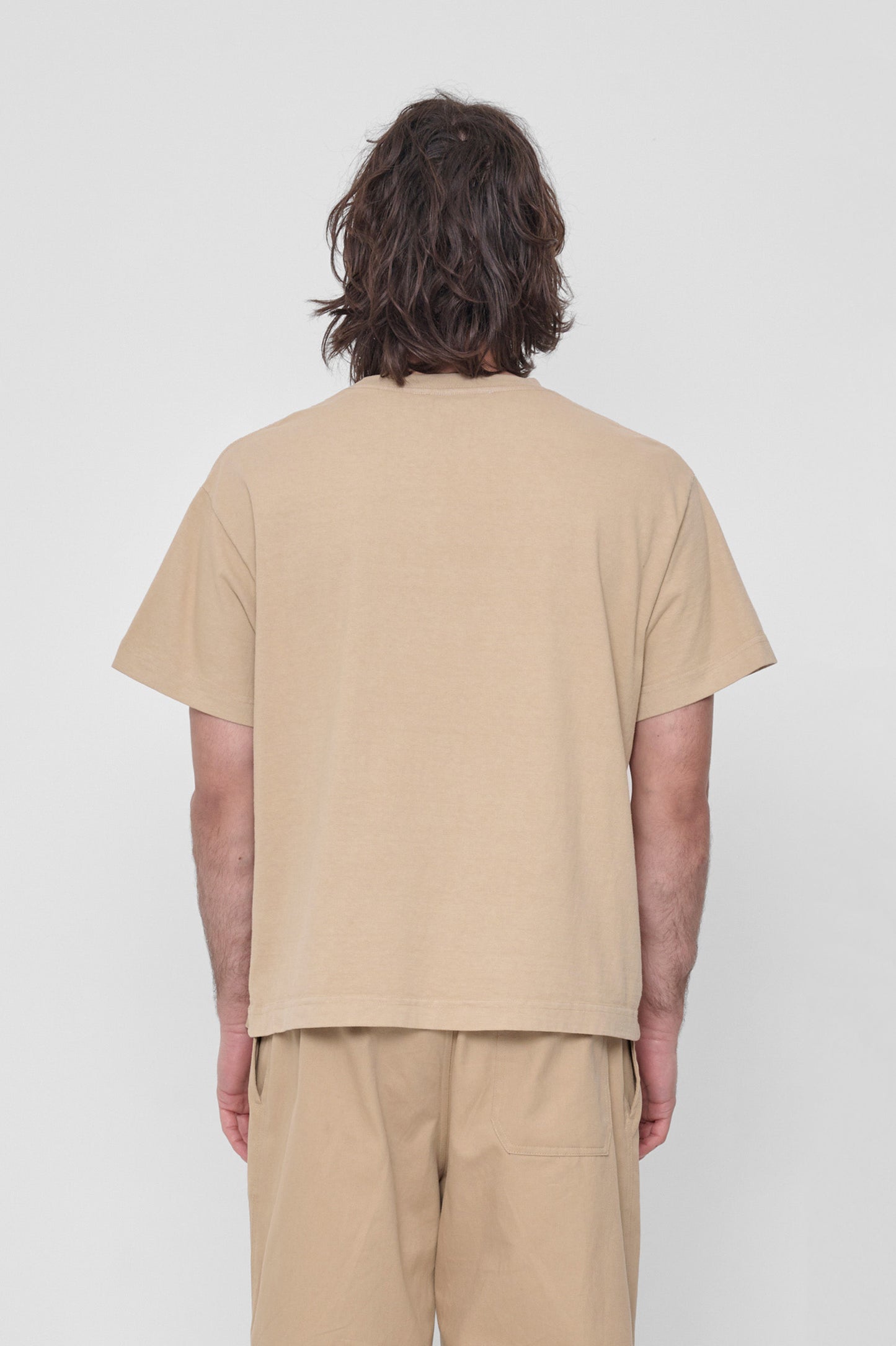 Back view shows relaxed fit and structured sleeves. 