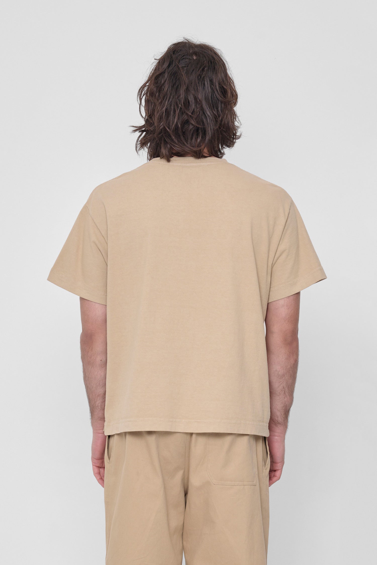 Back view shows relaxed fit and structured sleeves. 