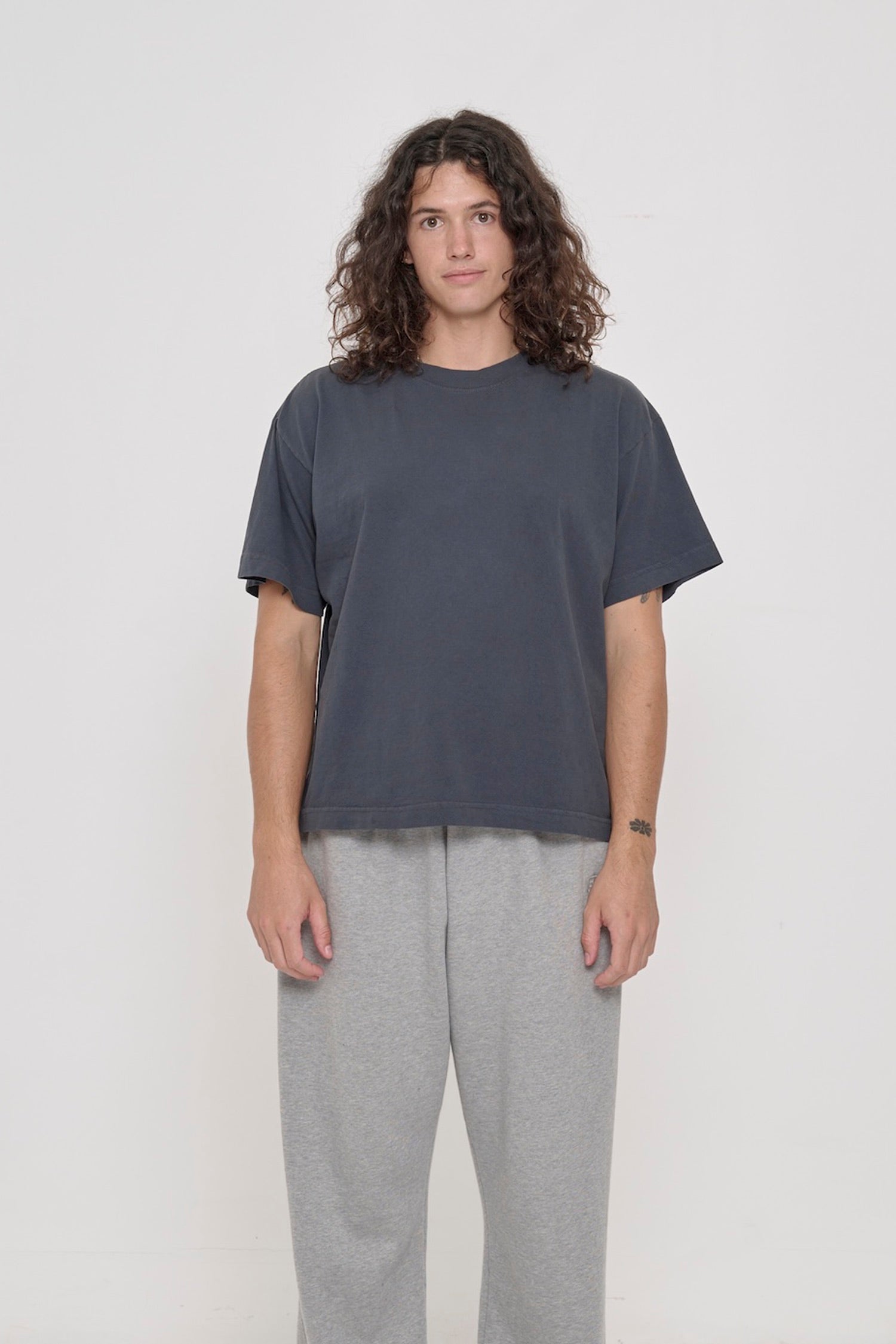 A 6' tall person wearing a Slate Heavyweight Boxier Trash Tee in size M. Hem is at their mid hip.