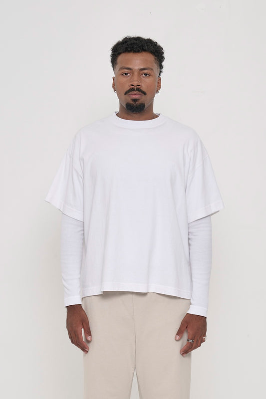A 6'2" person in a White Heavyweight Boxier Trash Tee in size L. Hem is at lower mid hip.