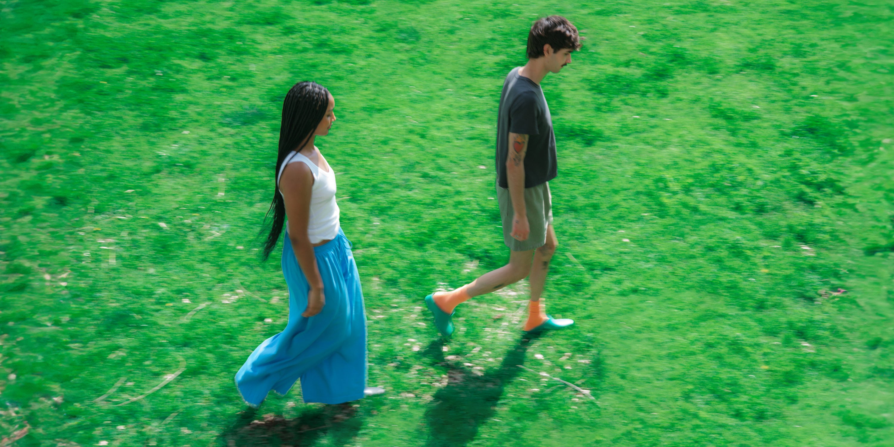 Two models walking on grass, shot on location in Los Angeles by Kaidan Pascua