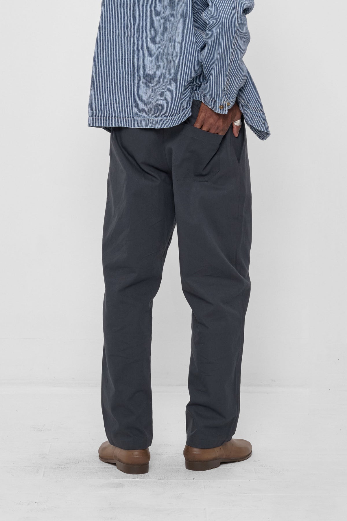 Life Uniform Pants in Slate – back view, model's hand in back pocket