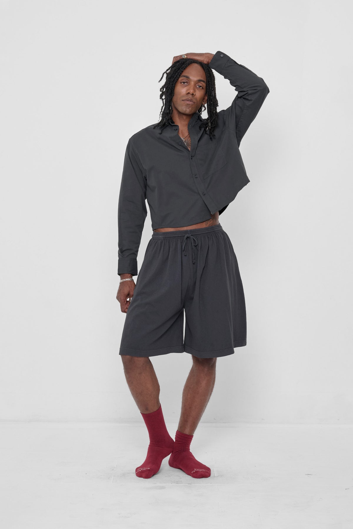 Long Tubular Shorts in Slate – front view on model, styled with matching Peach Fuzz Cropped Button-Up Shirt and Garnet Spring Socks