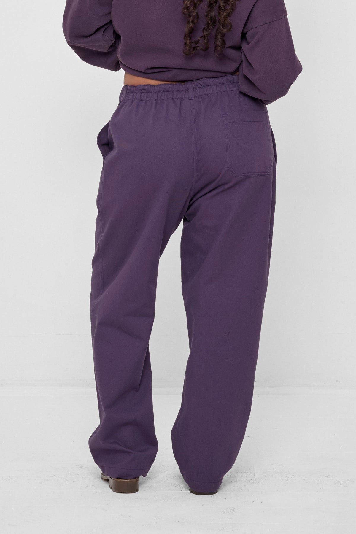 Life Uniform Pants in Washed Mulberry – back view on model