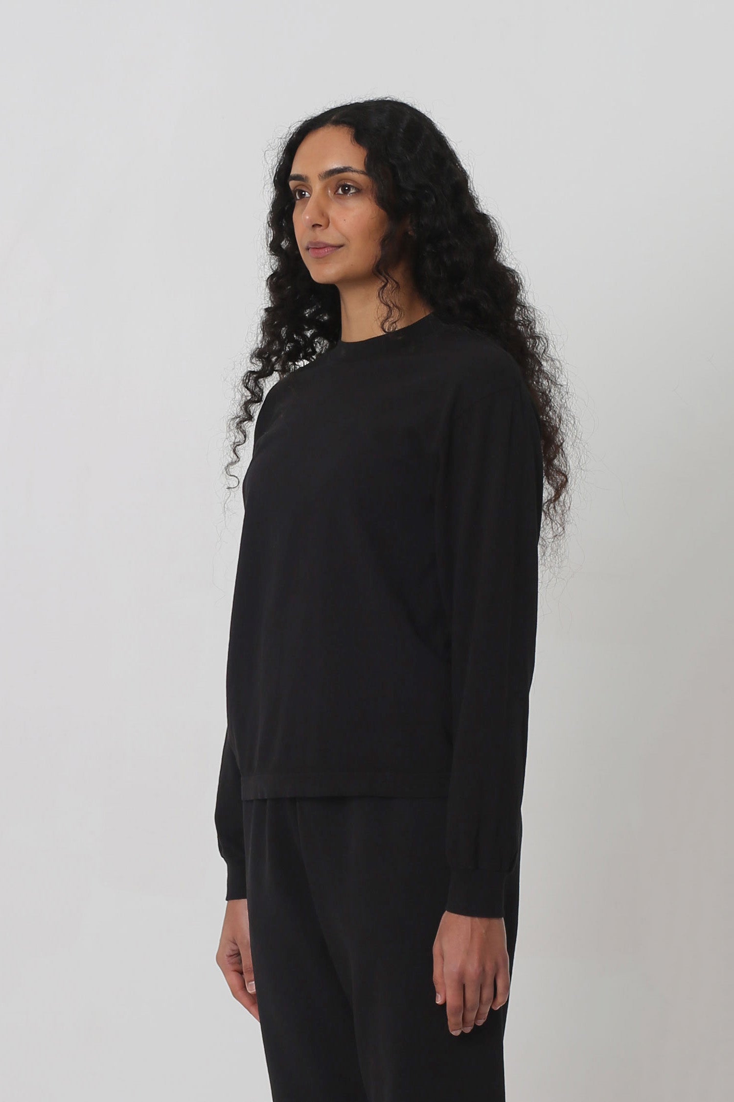 3/4 front view shows relaxed sleeves and rib cuff.