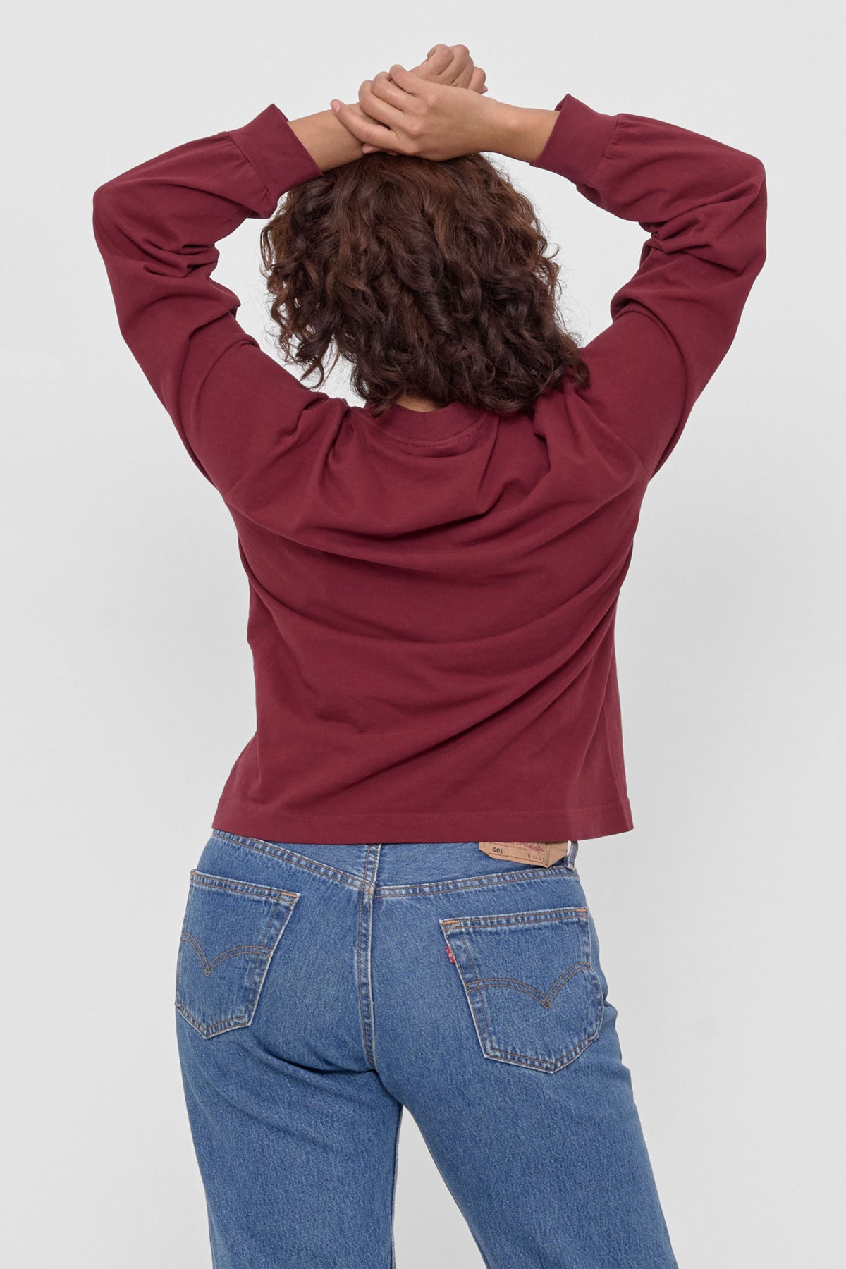 Long Sleeve Boxier Trash Tee in Garnet – back view on model