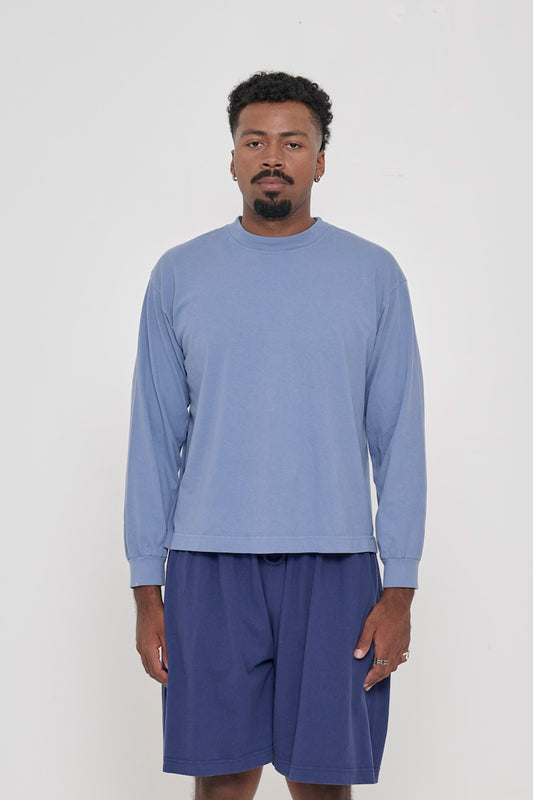 A 6'2" man in a size M Periwinkle Long Sleeve Boxier Trash Tee. Hem hits his upper middle hip.