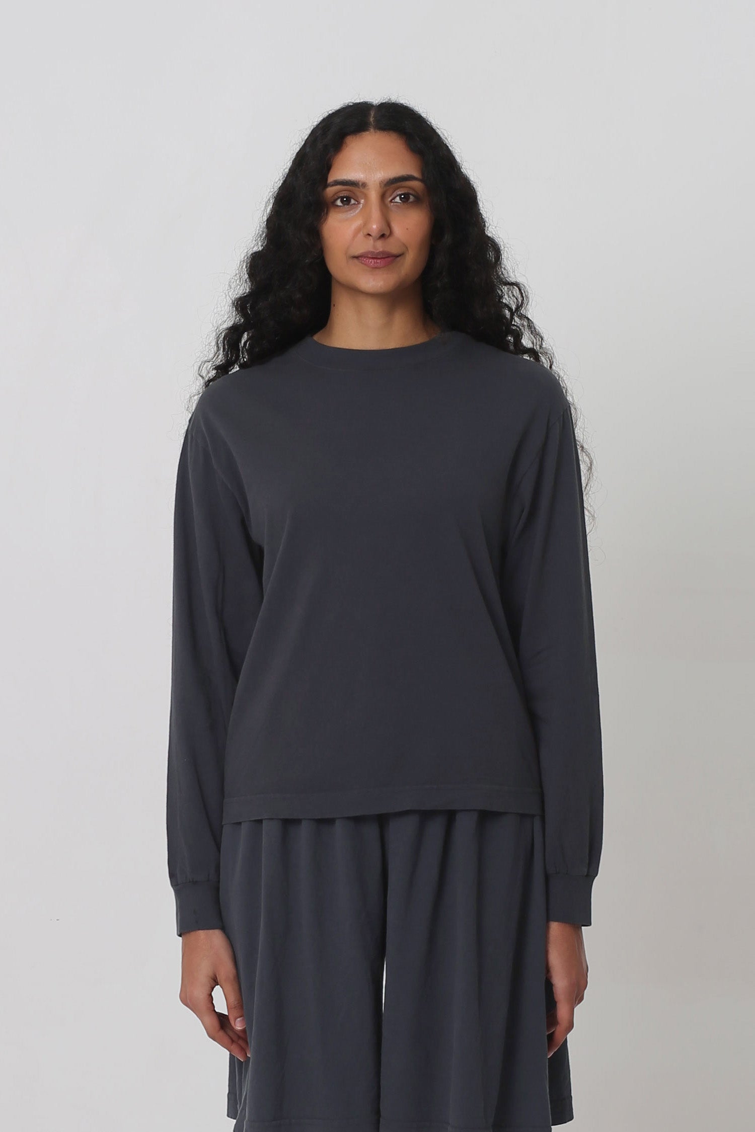 5'10" woman in an XS Slate Long Sleeve Boxier Trash Tee. Hem's at her upper-middle hip.