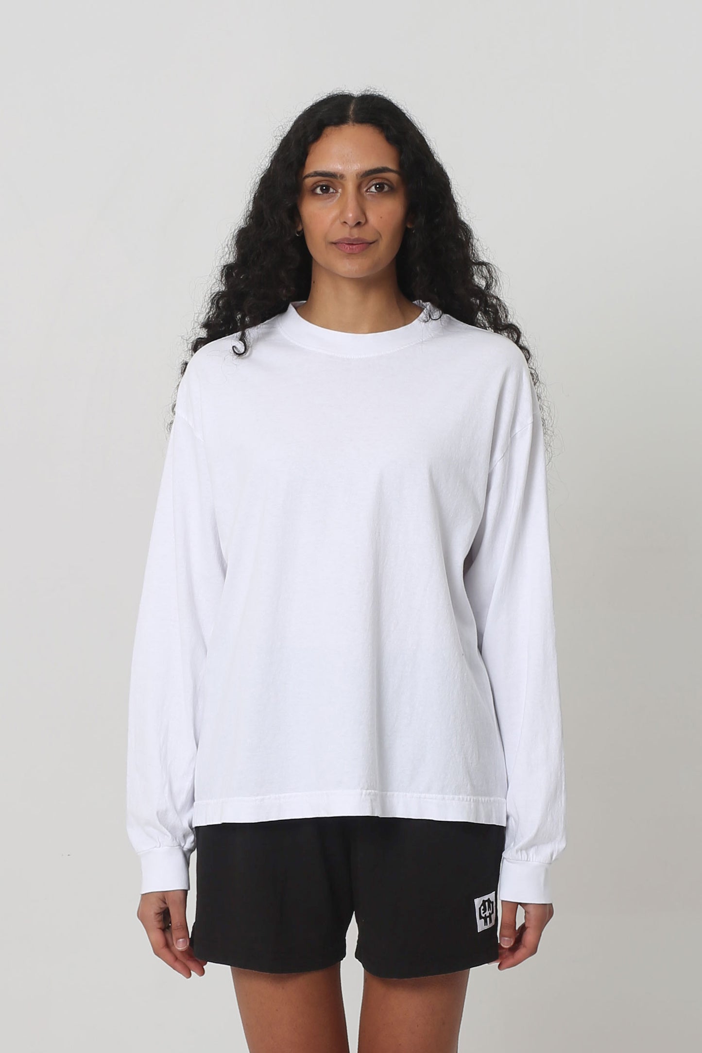 5'10" woman in a size S Long Sleeve Boxier Trash Tee. Hem ends at her lower-middle hip.