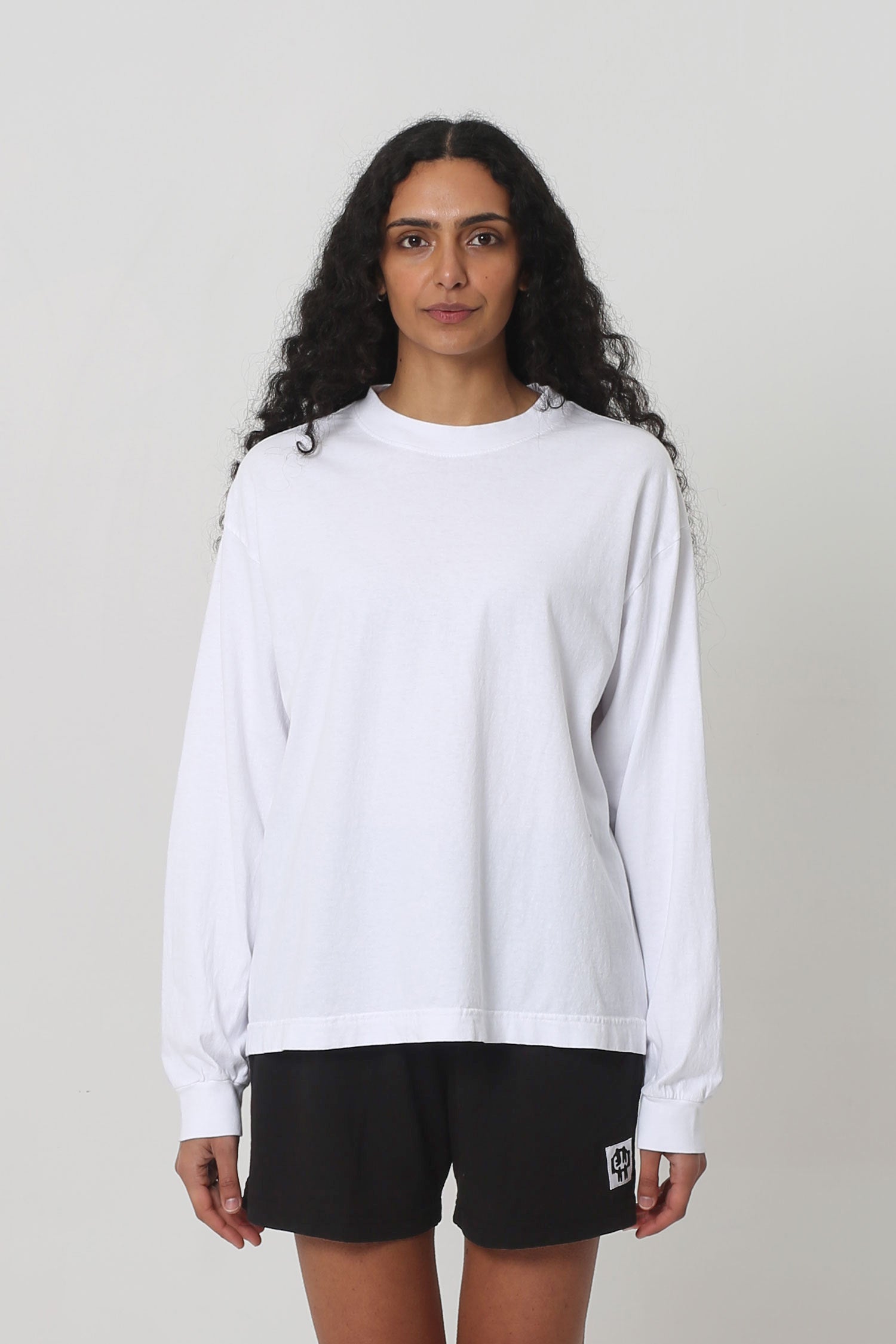 5'10" woman in a size S Long Sleeve Boxier Trash Tee. Hem ends at her lower-middle hip.
