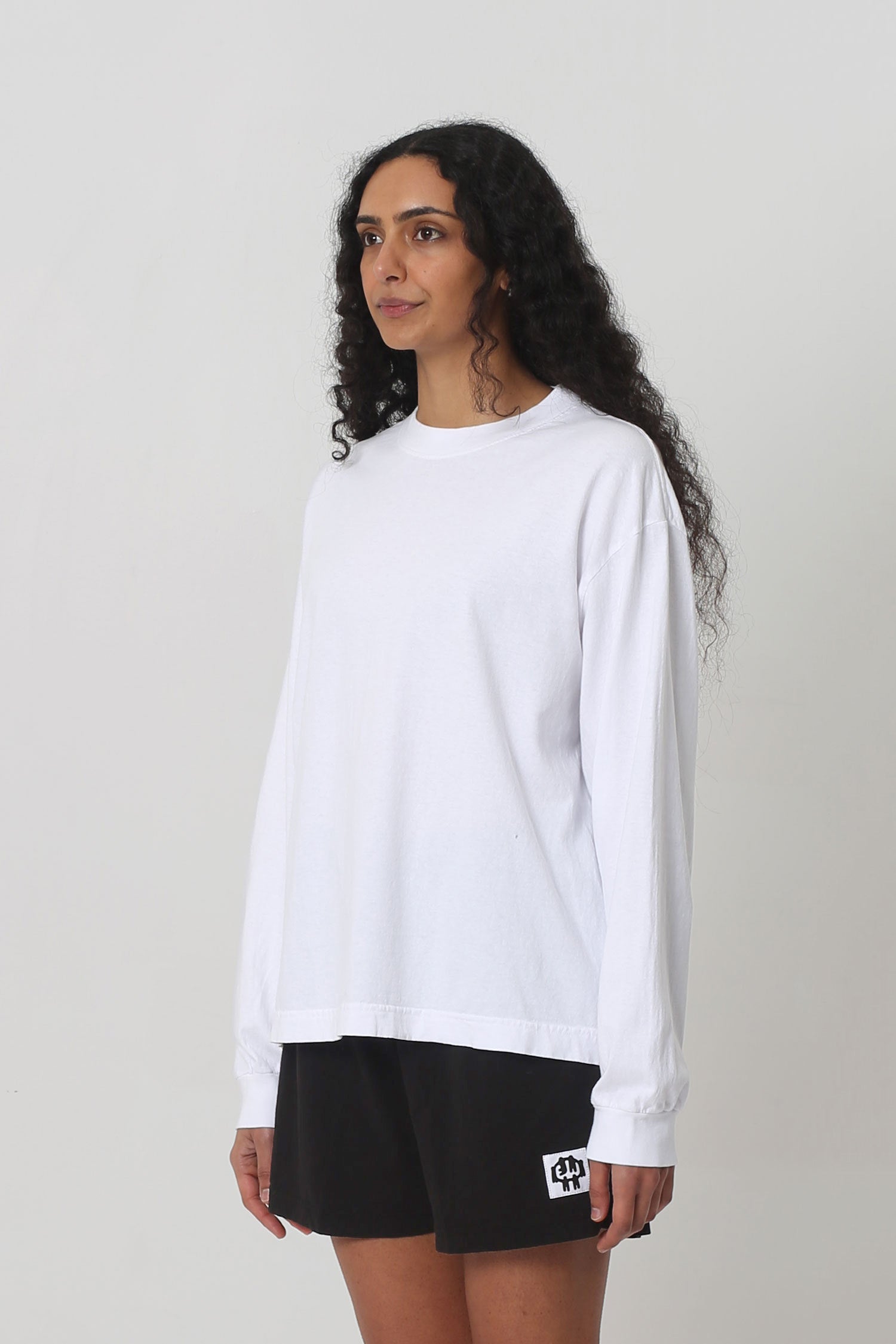 3/4 front view shows relaxed sleeves and rib cuff.