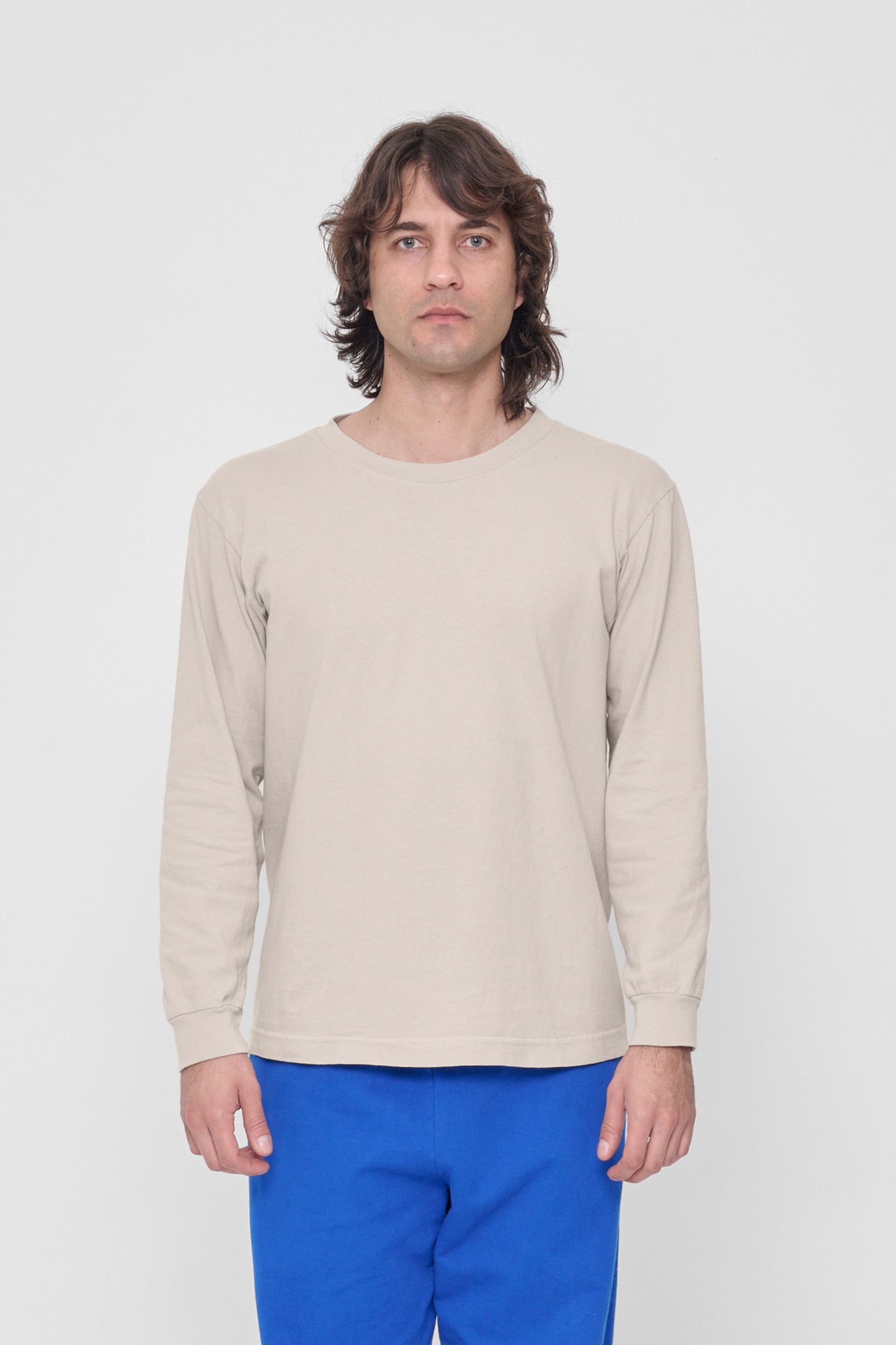 A 6'2" man in a Oat Long Sleeve Trash Tee in size M. Hem hits just below his hip.