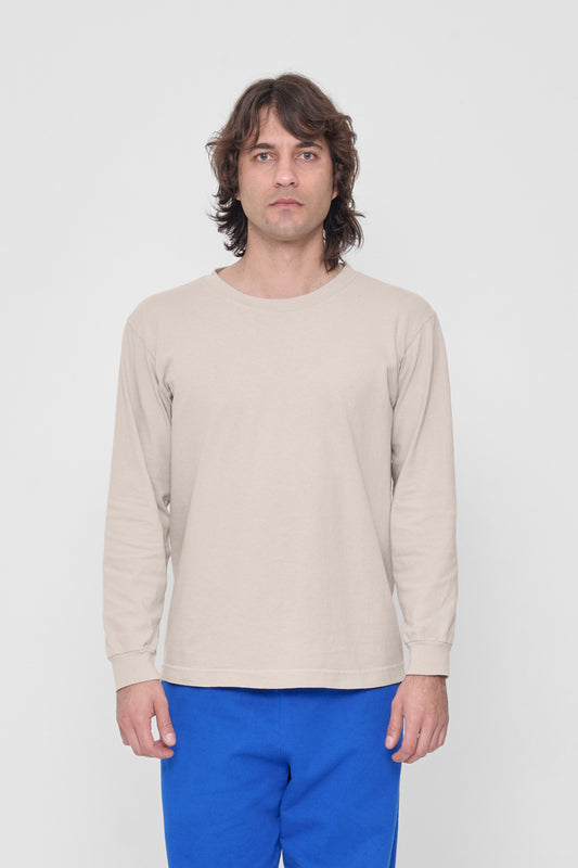 A 6'2" man in a Oat Long Sleeve Trash Tee in size M. Hem hits just below his hip.