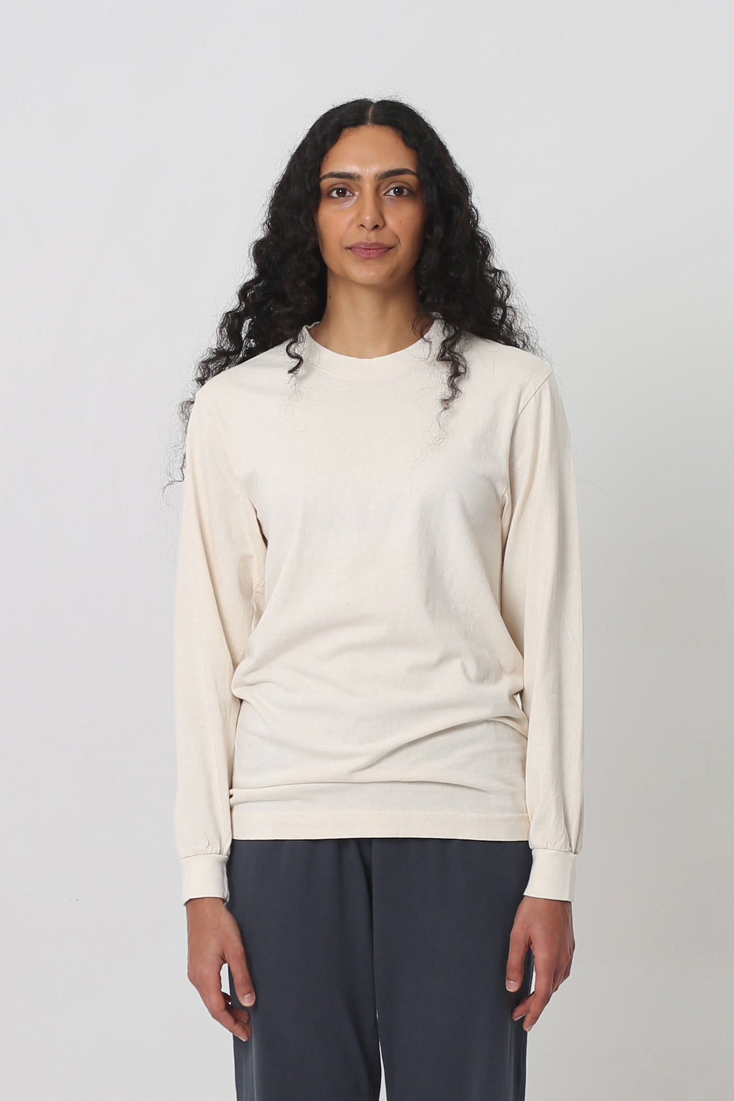 5'10" woman in size S Scour Long Sleeve Trash Tee; shirt hem scrunched up to low hip.