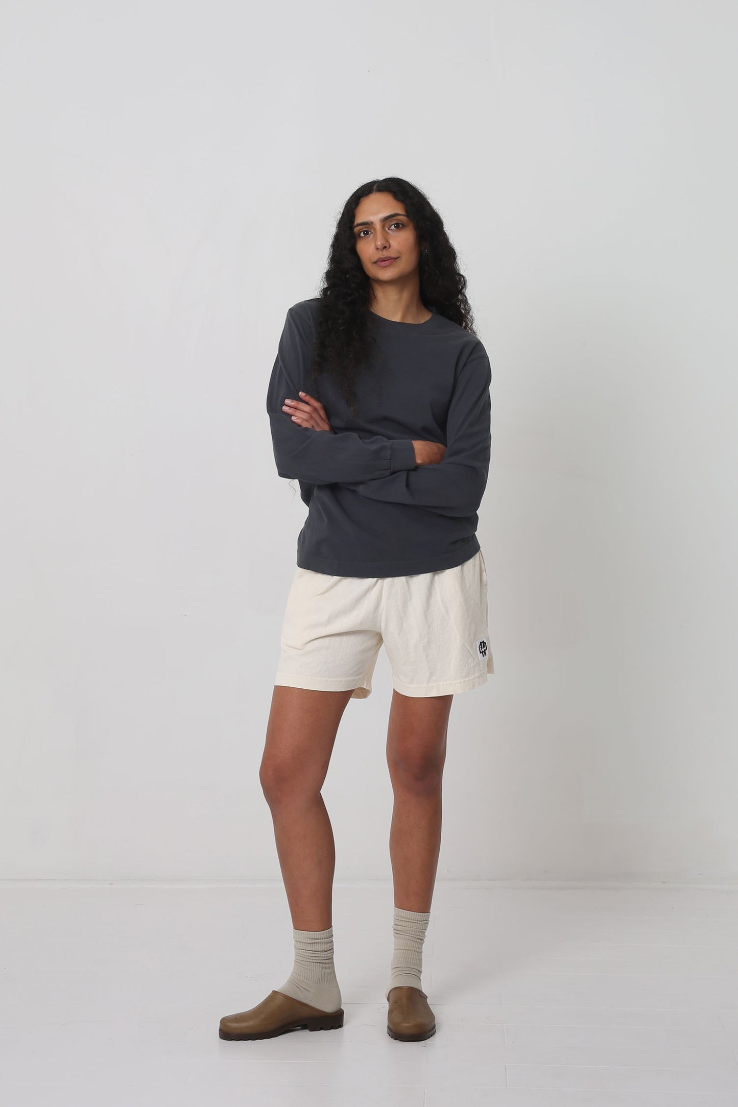 Styled with Scour Everyday Shorts, Oat Squishy Socks and Plasticana Opana Mules.