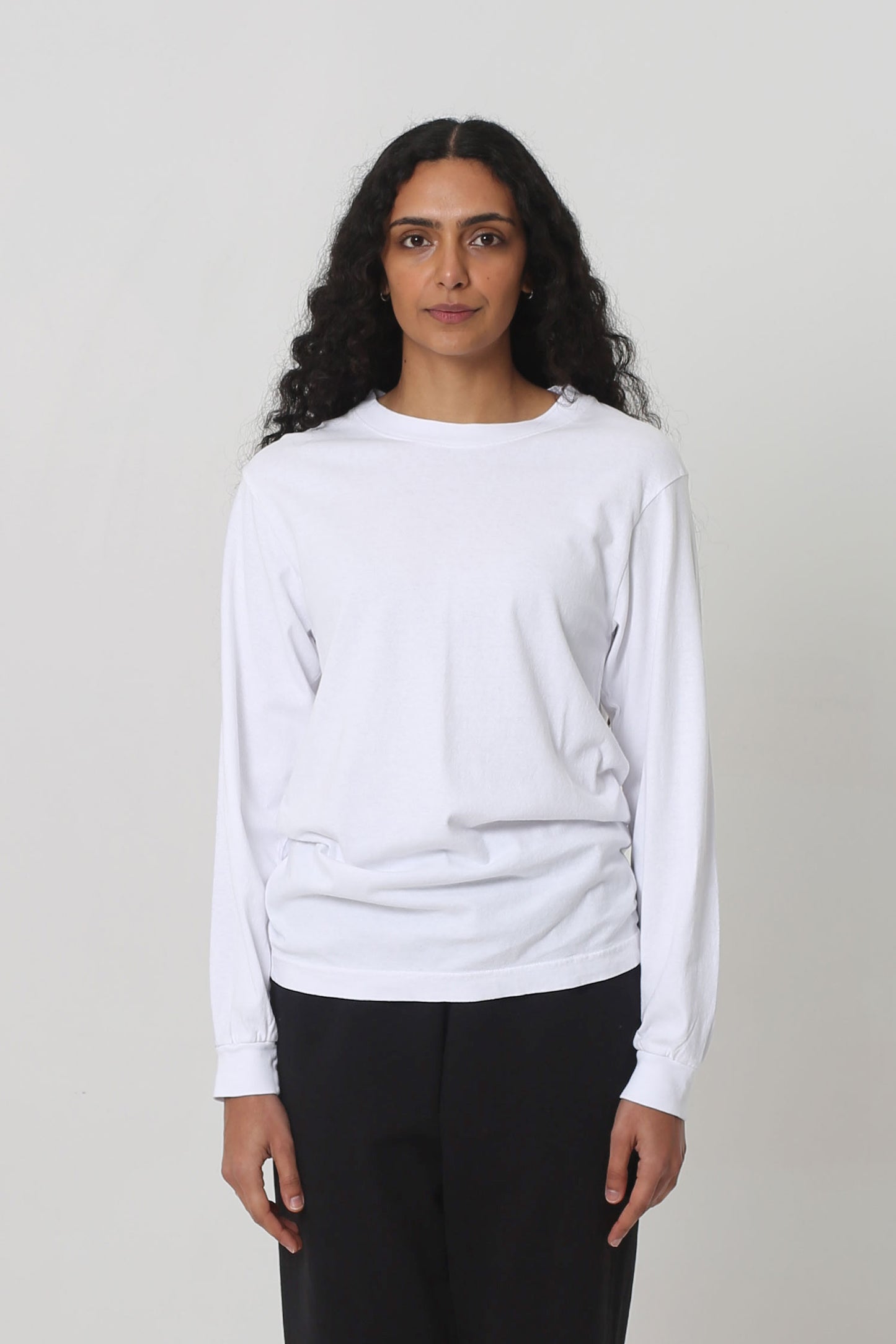 5'10" woman in size S White Long Sleeve Trash Tee; shirt hem scrunched up to low hip.