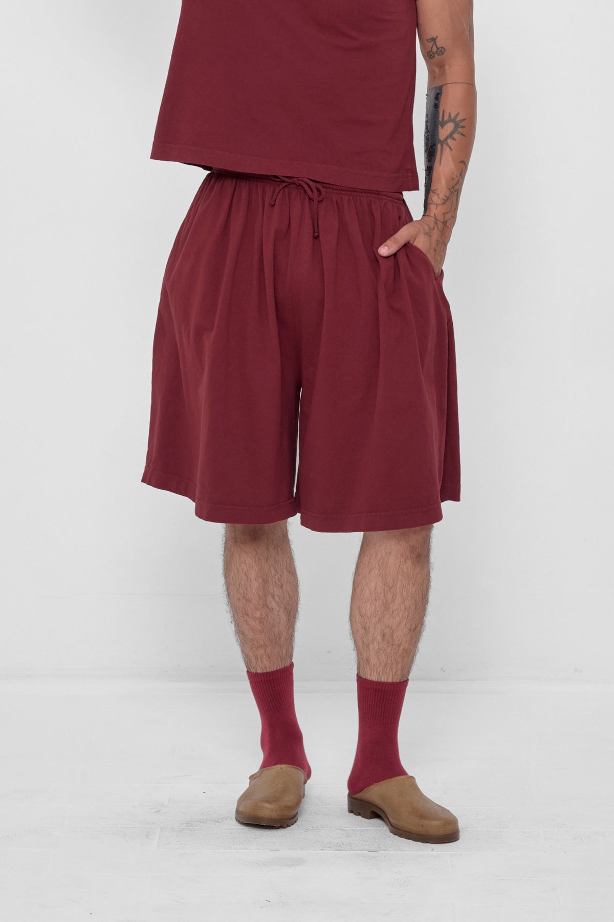 Long Tubular Shorts in Garnet – front view on model