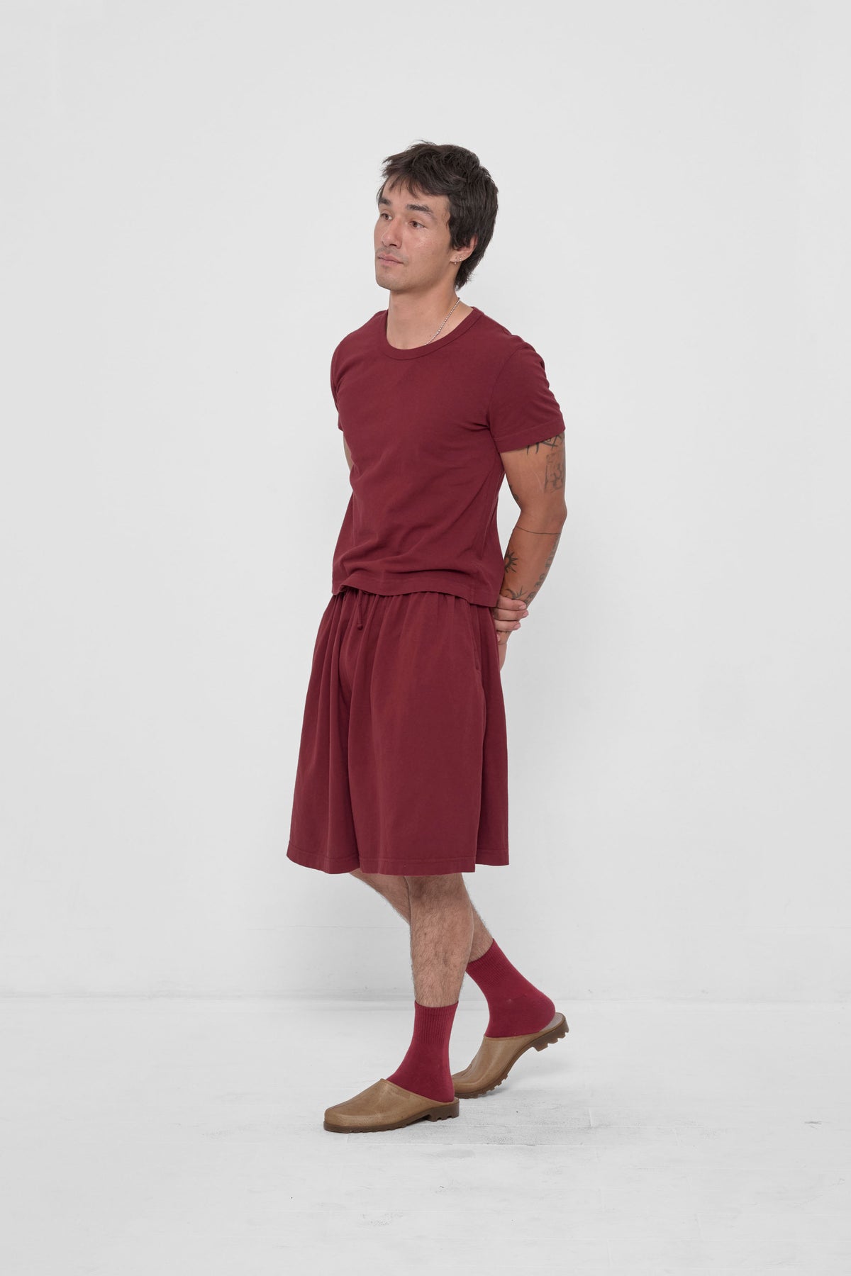 Long Tubular Shorts in Garnet – 3/4 front view on model, styled with matching Spring Socks and Tailored Trash Tee and Plasticana mules