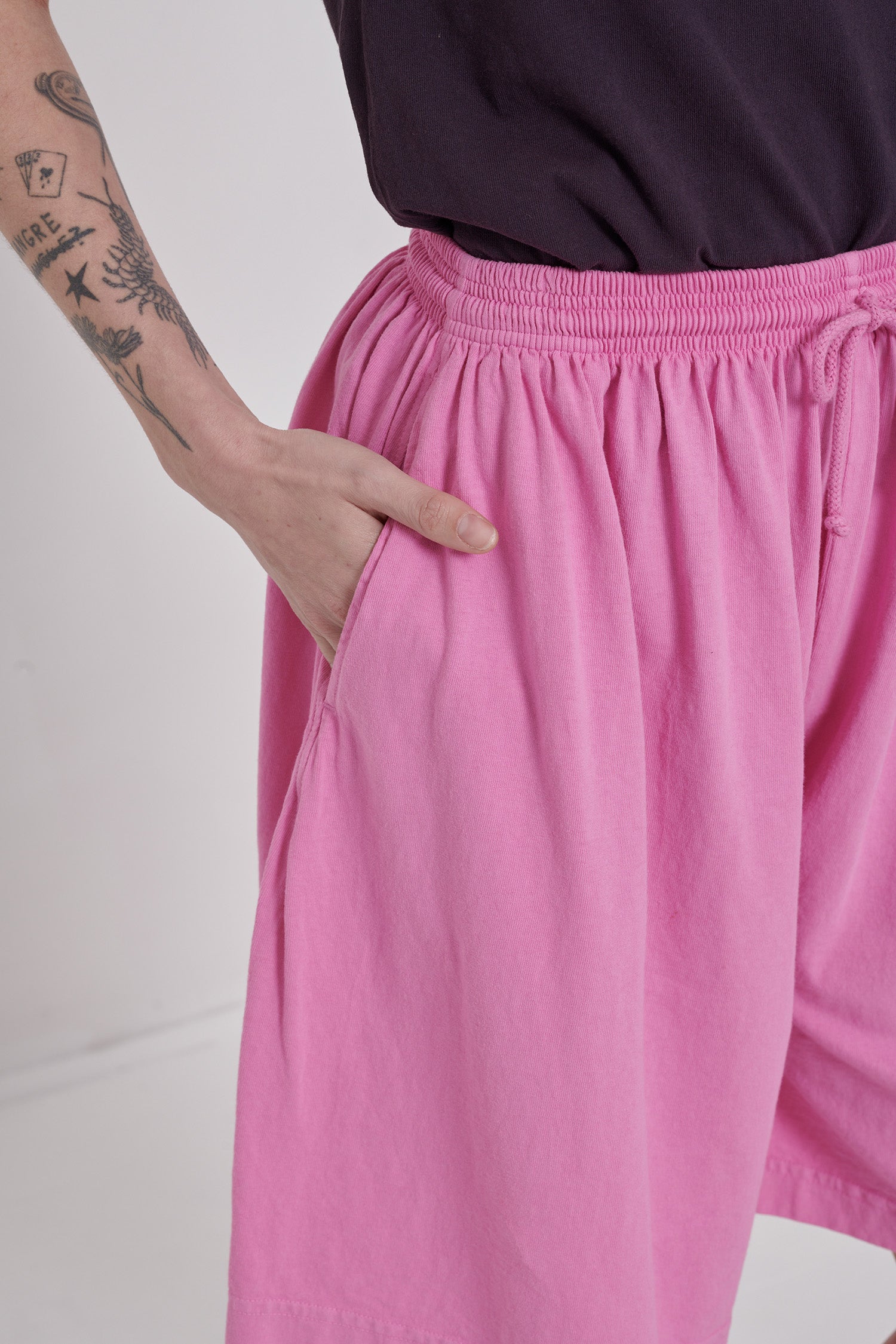 Close up detail of side seam pocket and elasticated waist band. 