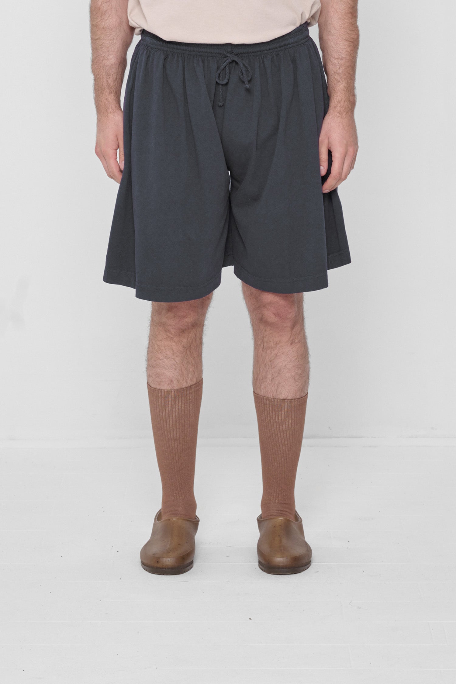 A 6'2" person in Low Rise Slate Long Tubular Shorts. Hem ends at the knee.