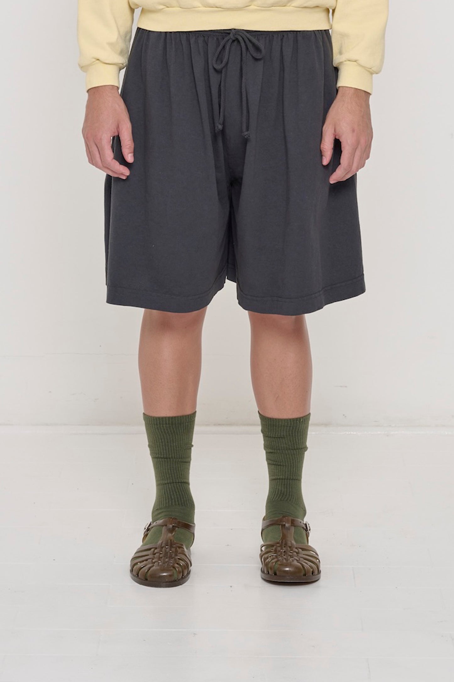 Waist down of a 6' person in Slate Long Tubular Short. Shows fabric gathers from the waist and waistband drawcord tied.