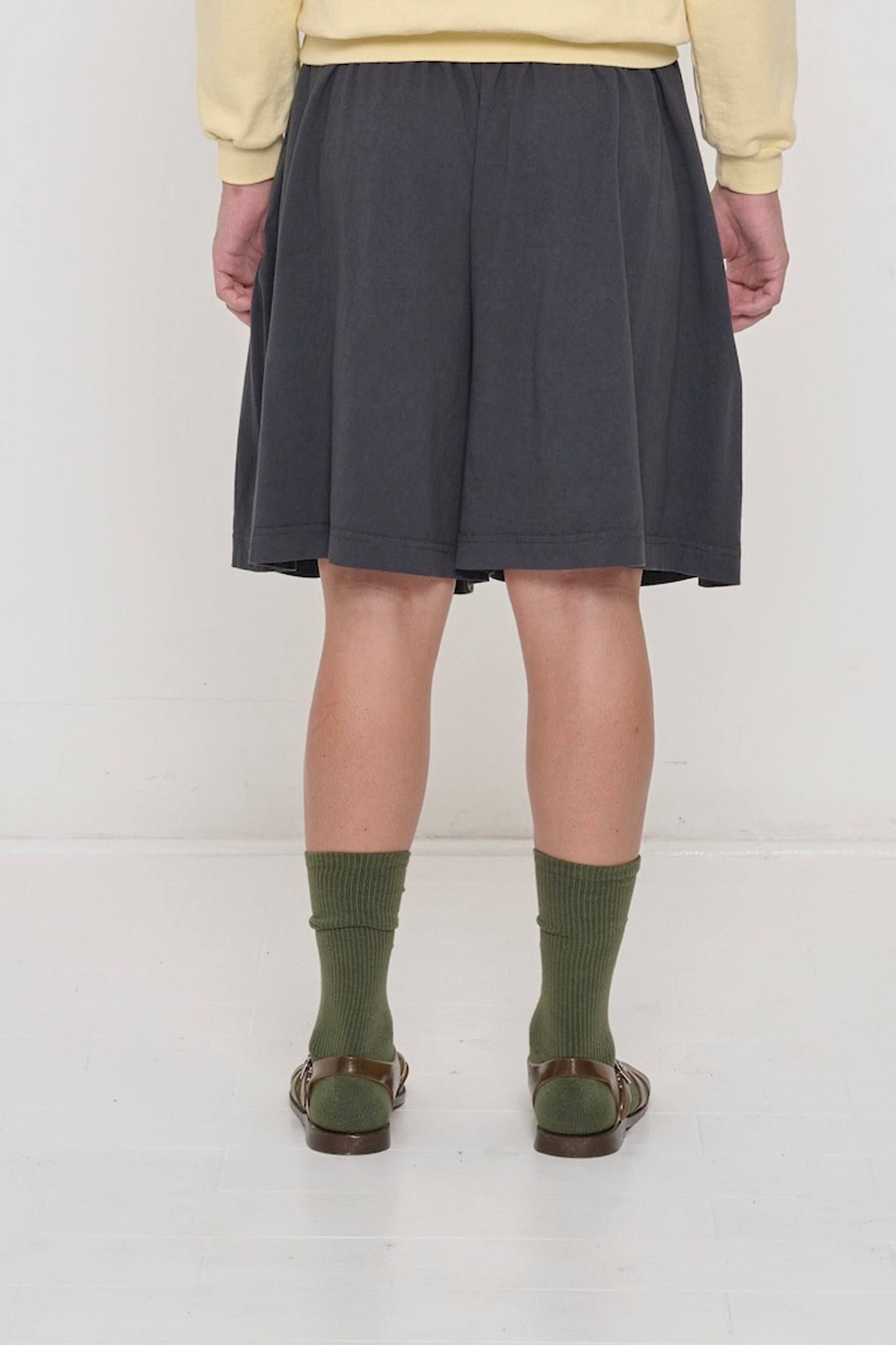 Back view: Slate Long Tubular Shorts on a person, waist down, showing drapey fit.