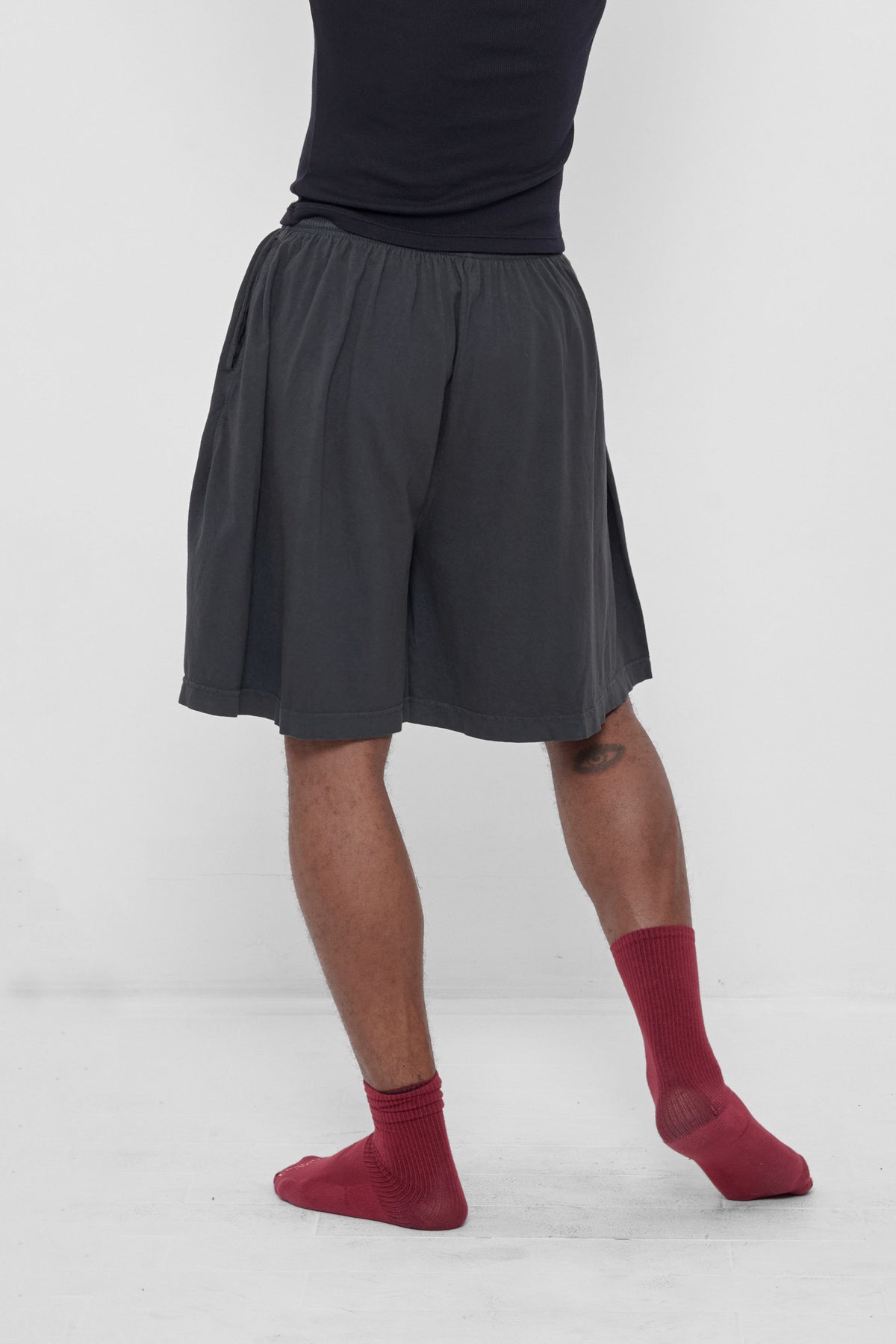 Long Tubular Shorts in Slate – back view on model