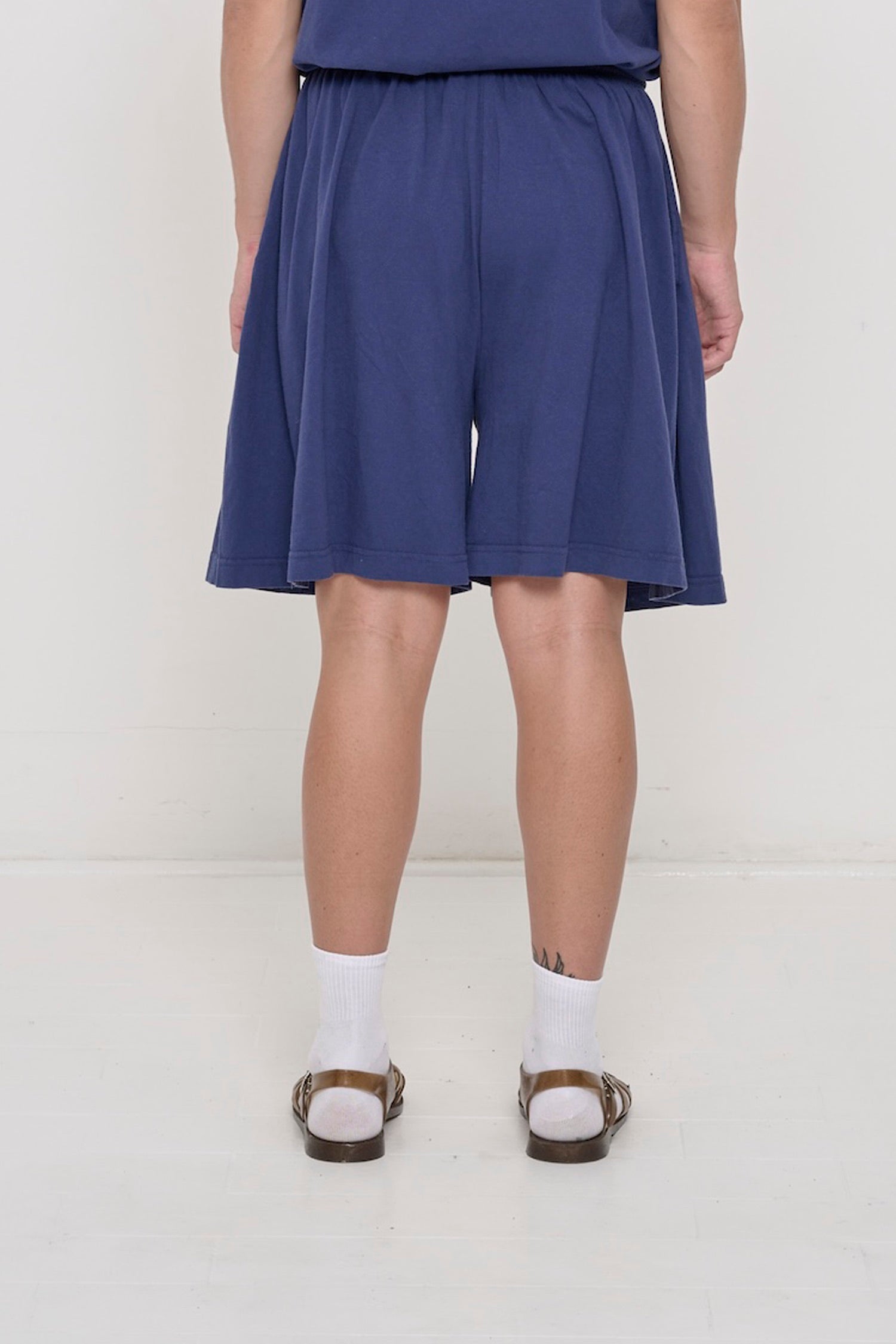 Back close-up on Washed Navy Long Tubular Shorts highlighting the relaxed fit.