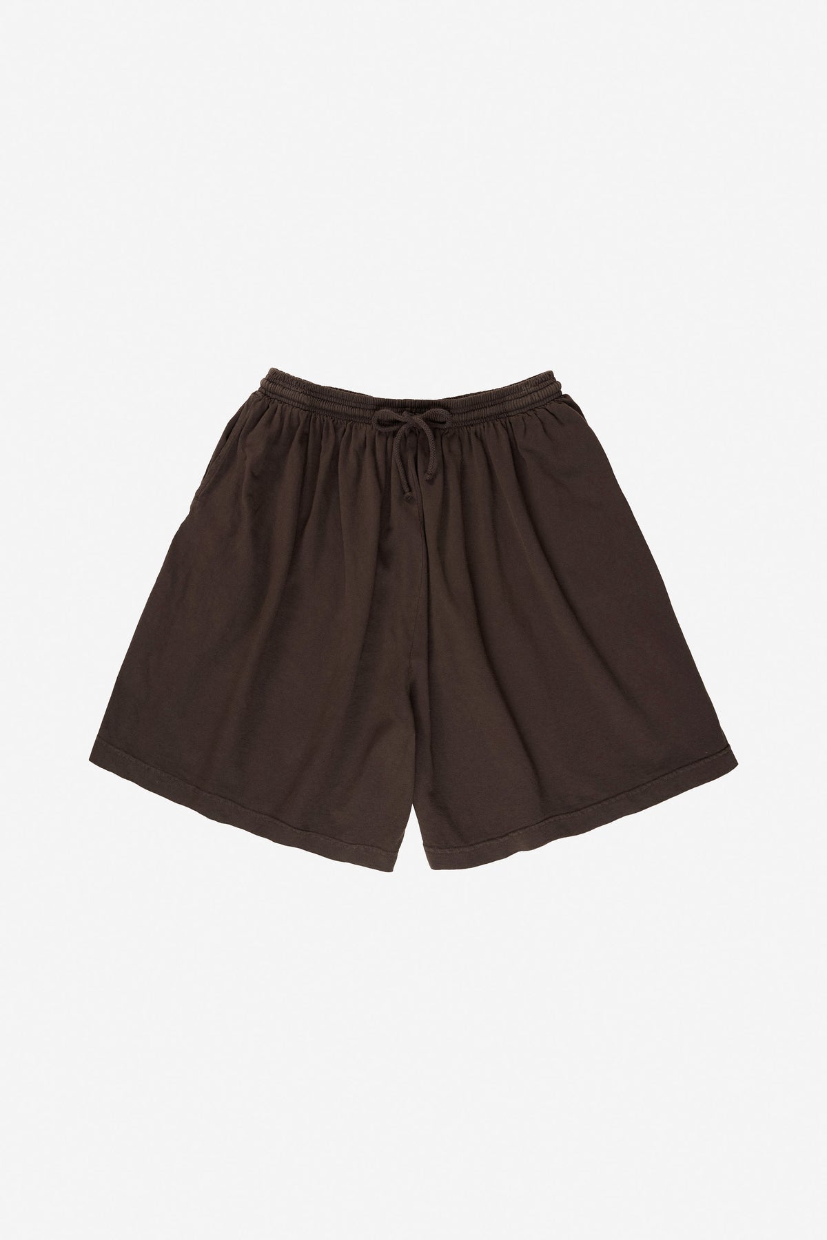 Long Tubular Shorts in Wet Soil – flat lay, no model