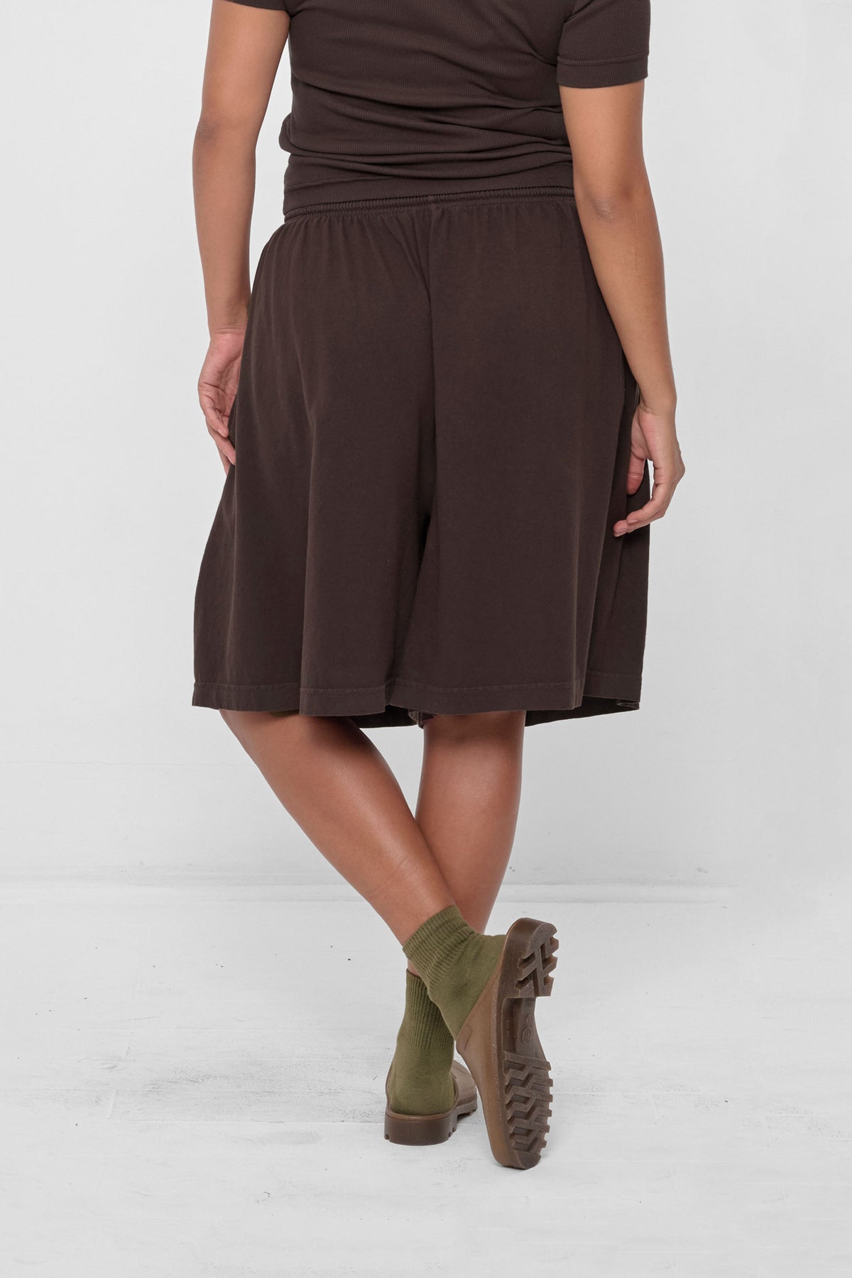 Long Tubular Shorts in Wet Soil – back view on model