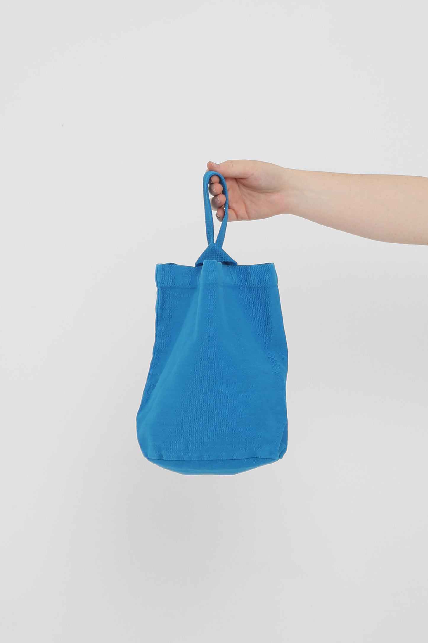 Malibu Loop Tote: longer strap front-facing, hand-held, showcasing gussets, depth, and stitching.
