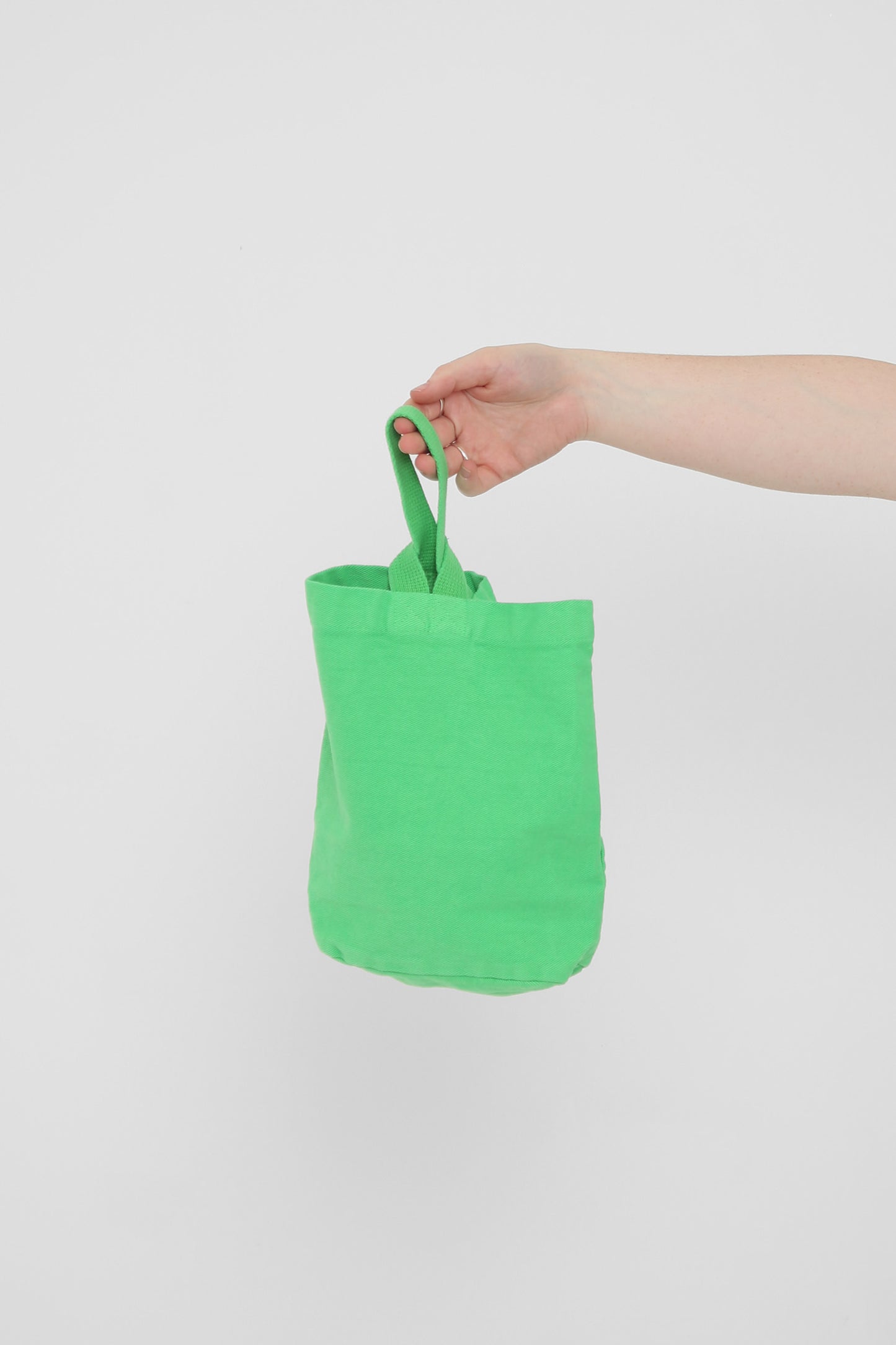 Nice Grass Loop Tote: longer strap front-facing, hand-held, showcasing gussets and stitching.