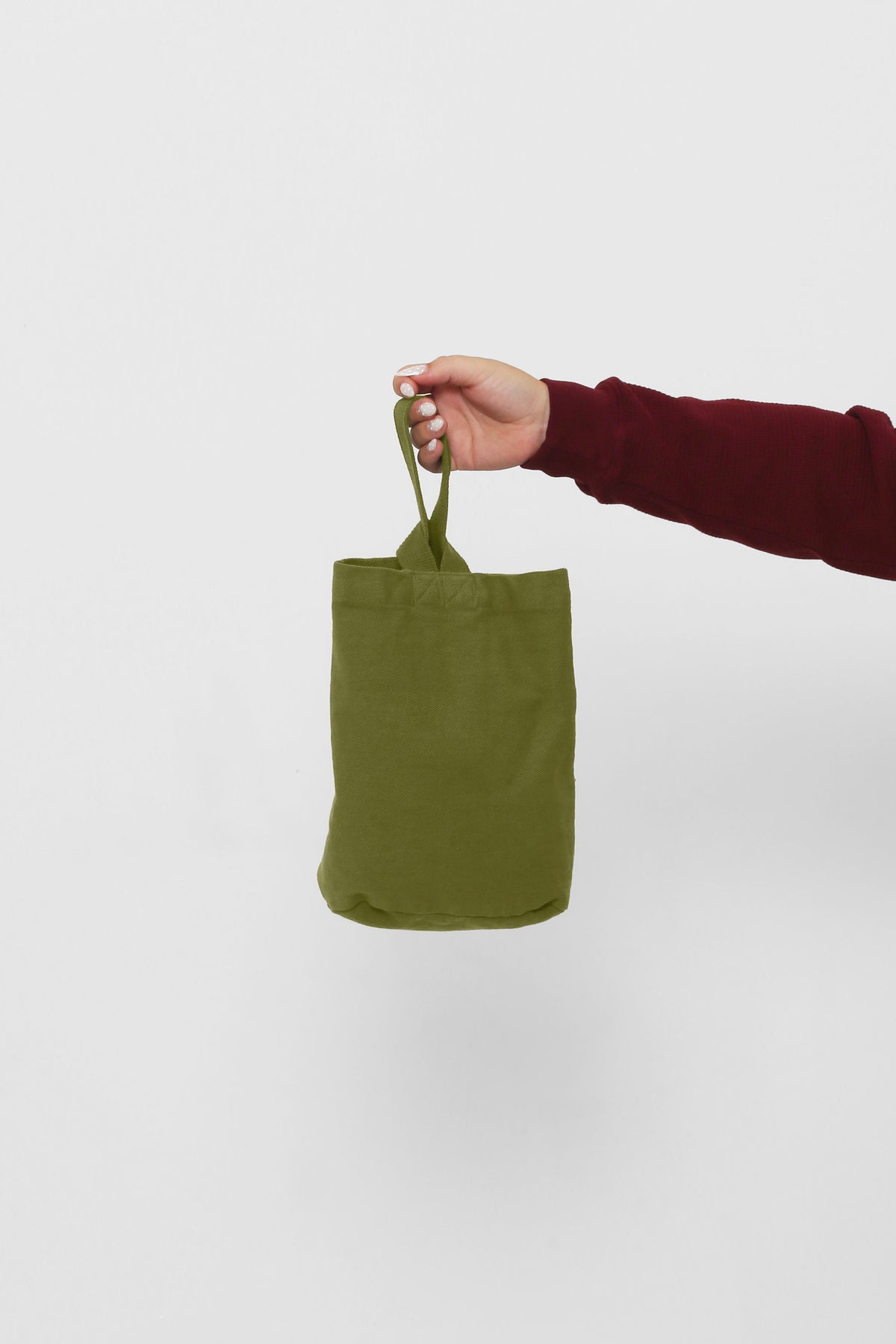 Olive Loop Tote: longer strap front-facing, hand-held, showcasing gussets, depth, and stitching.