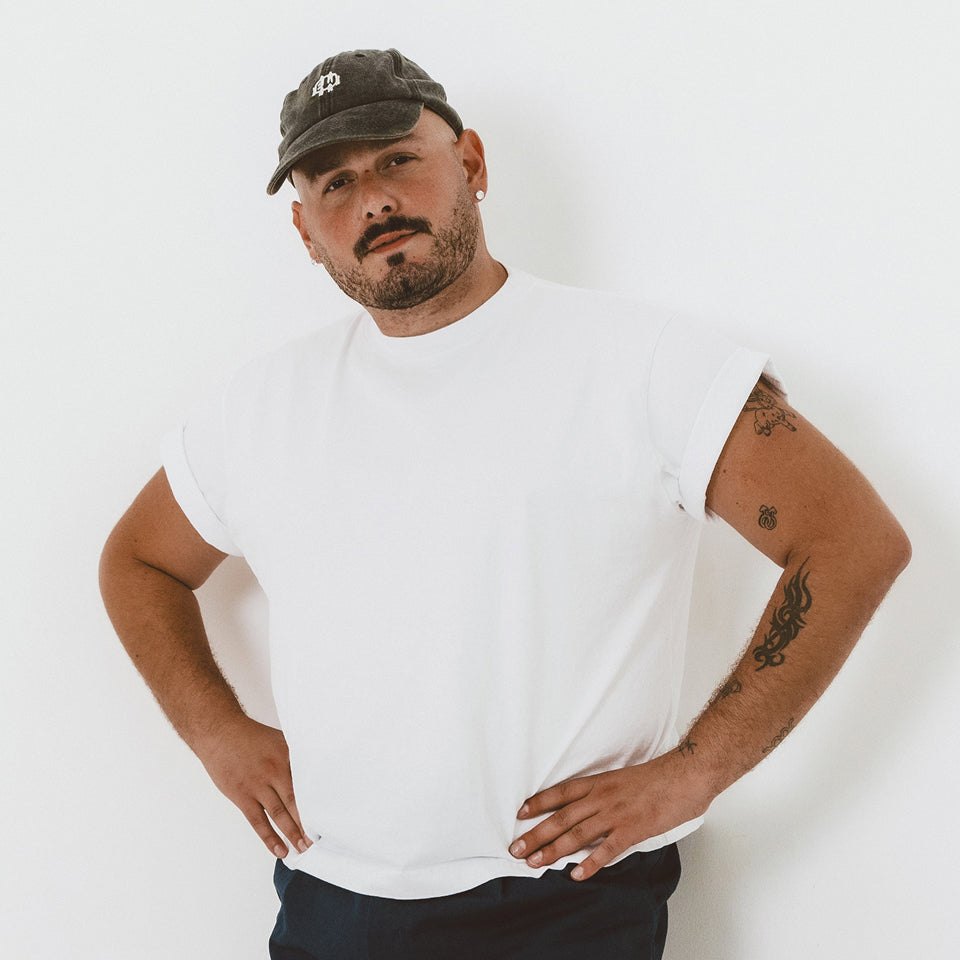 Man wearing a Boxier Trash Tee in White with hands on his hips. 