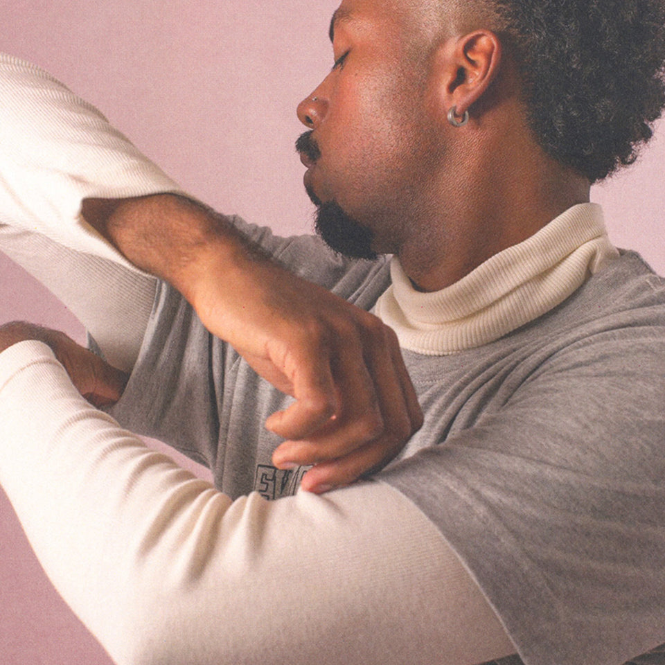 Man adjust sleeve of Rib Turtleneck in Natural.