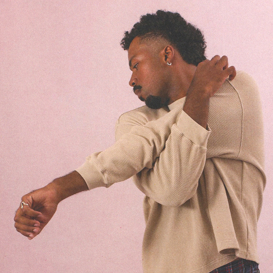 Man stretching wearing Thermal Long Sleeve Boxier Trash Tee in Oat.