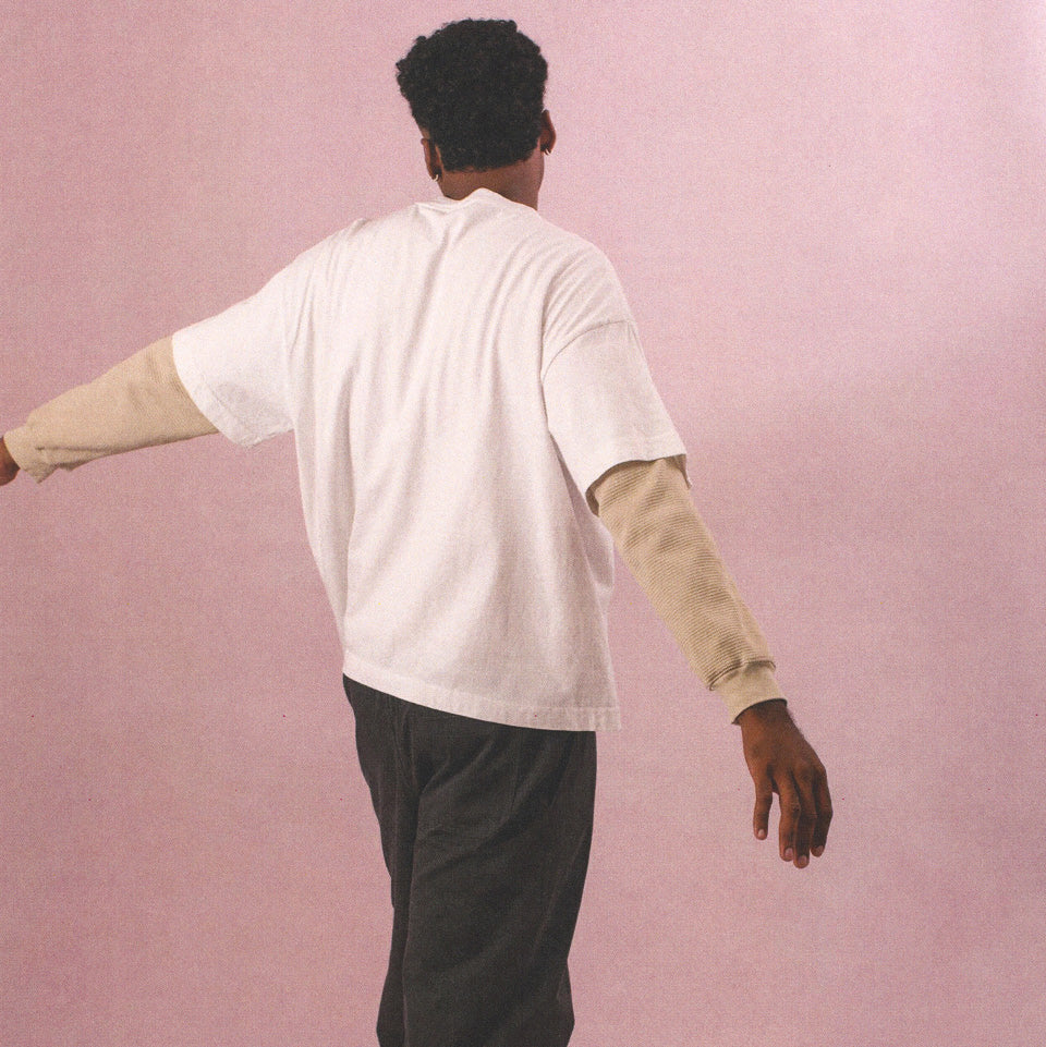 Person wearing Heavyweight Boxier Trash Tee in White, Thermal Long Sleeve Boxier Trash Tee and Life Uniform Pants in Slate.