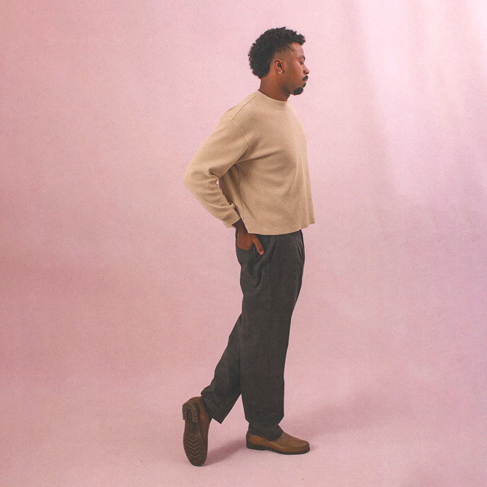 Man with hands in his back pockets, wearing Thermal Long Sleeve Boxier Trash Tee and Cotton Twill Life Uniform Pants.