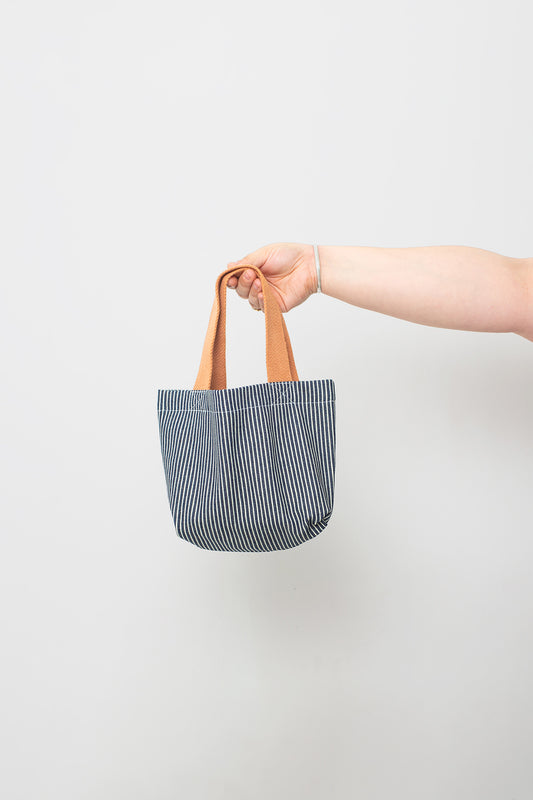 Railroad Scrap Tote, held by the orangey-light-brown straps.