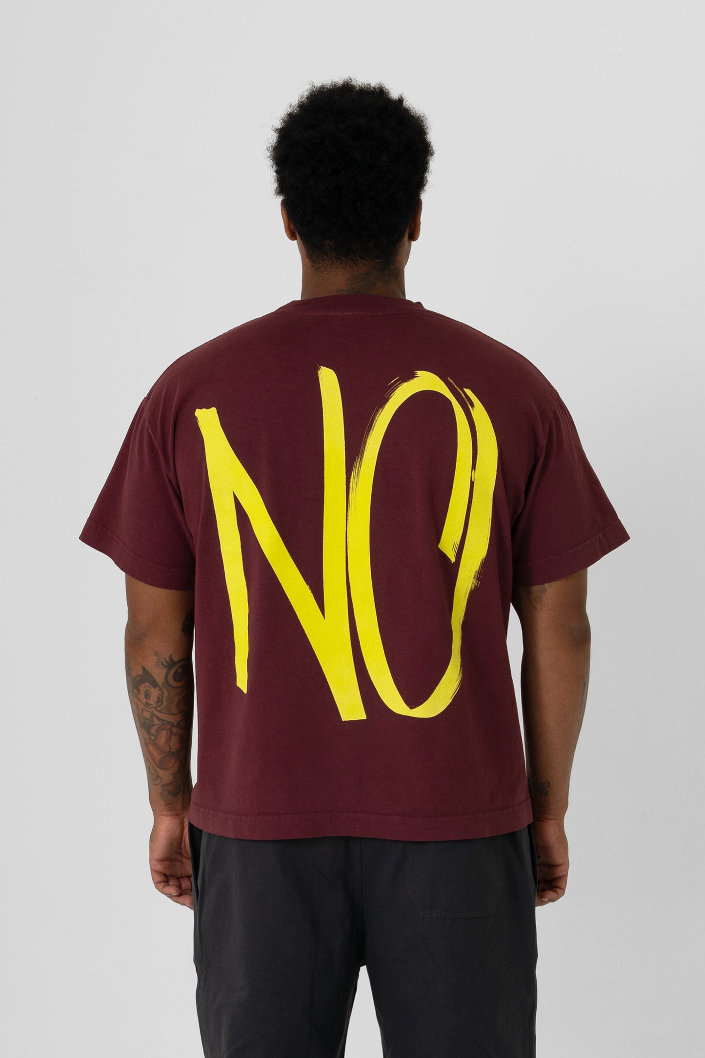 Back view showing the graphic, fabric drape and relaxed fit throughout.