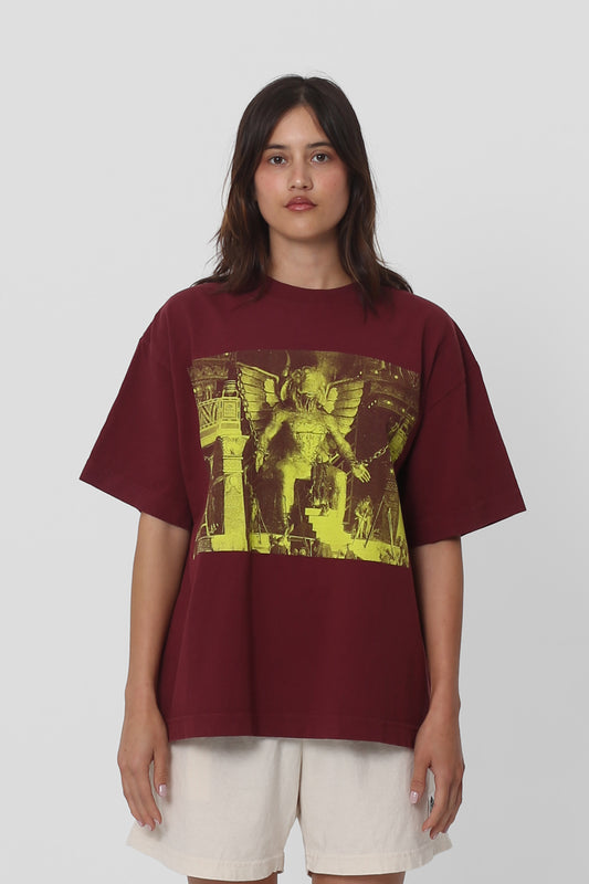 5'5" woman in a size S Burgundy Boxier Trash Tee. Hem at her middle hip.