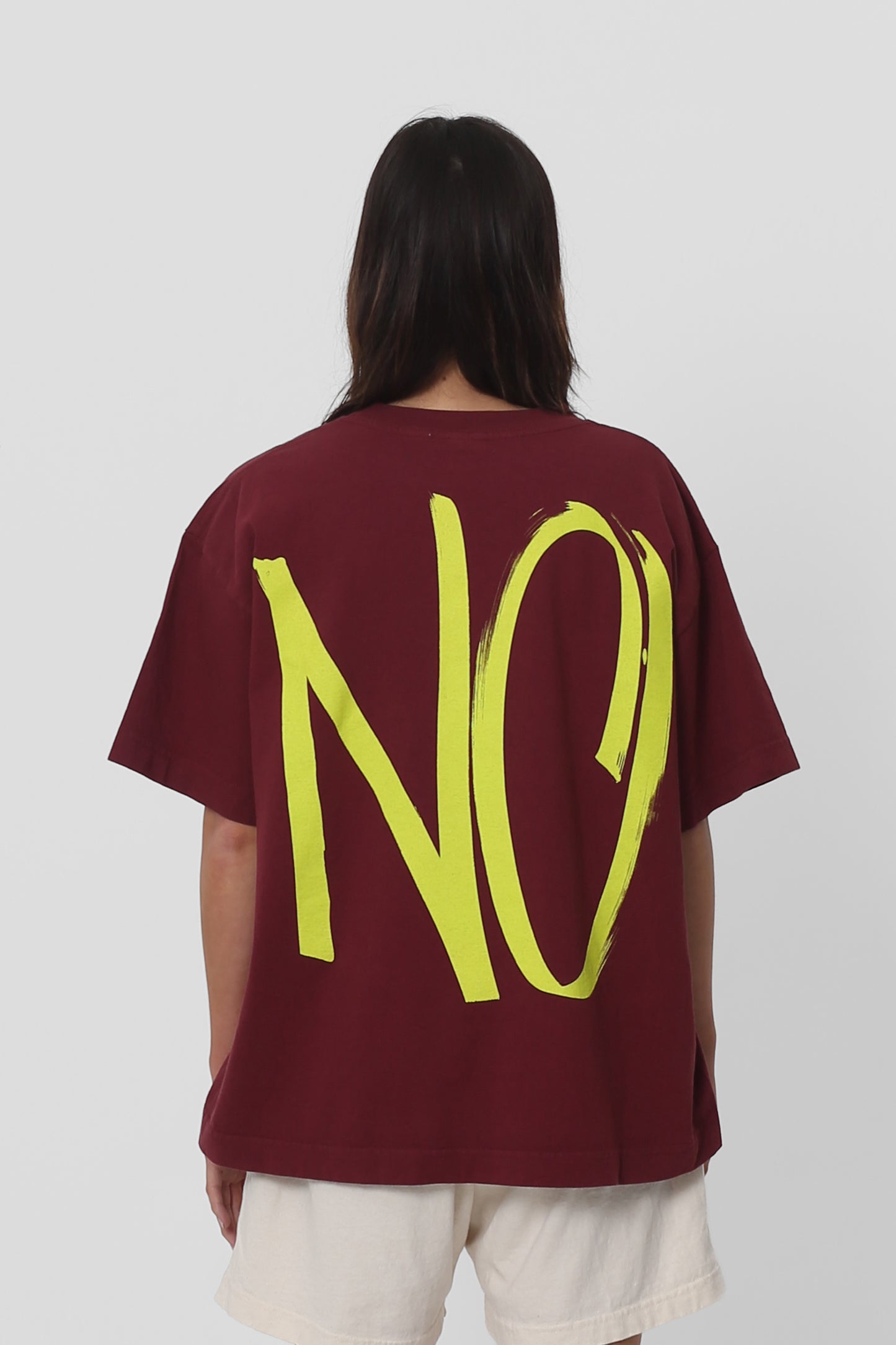 Back view showing the graphic, fabric drape and relaxed fit throughout.