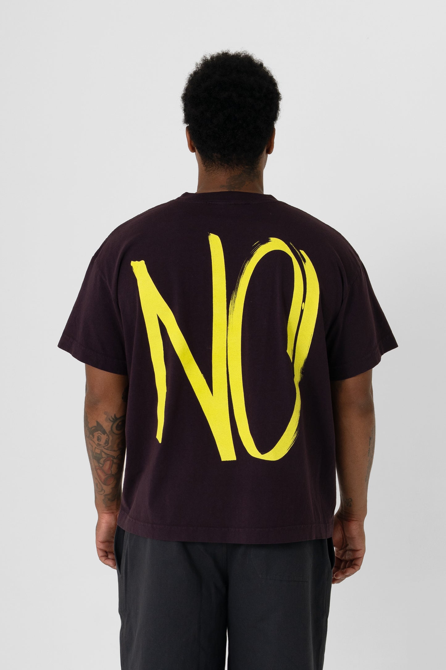 Back view showing the graphic, fabric drape and relaxed fit throughout.