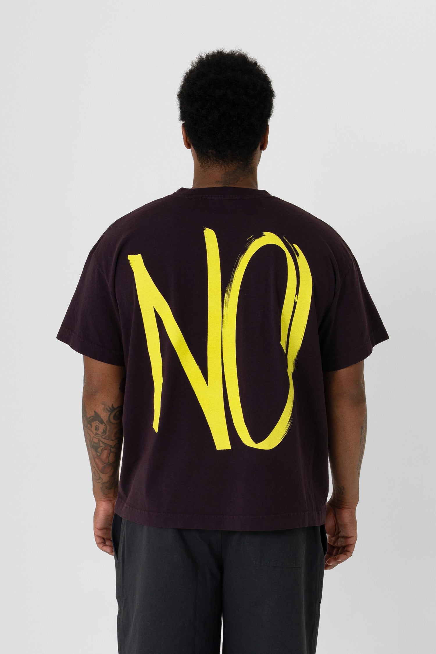 Back view showing the graphic, fabric drape and relaxed fit throughout.