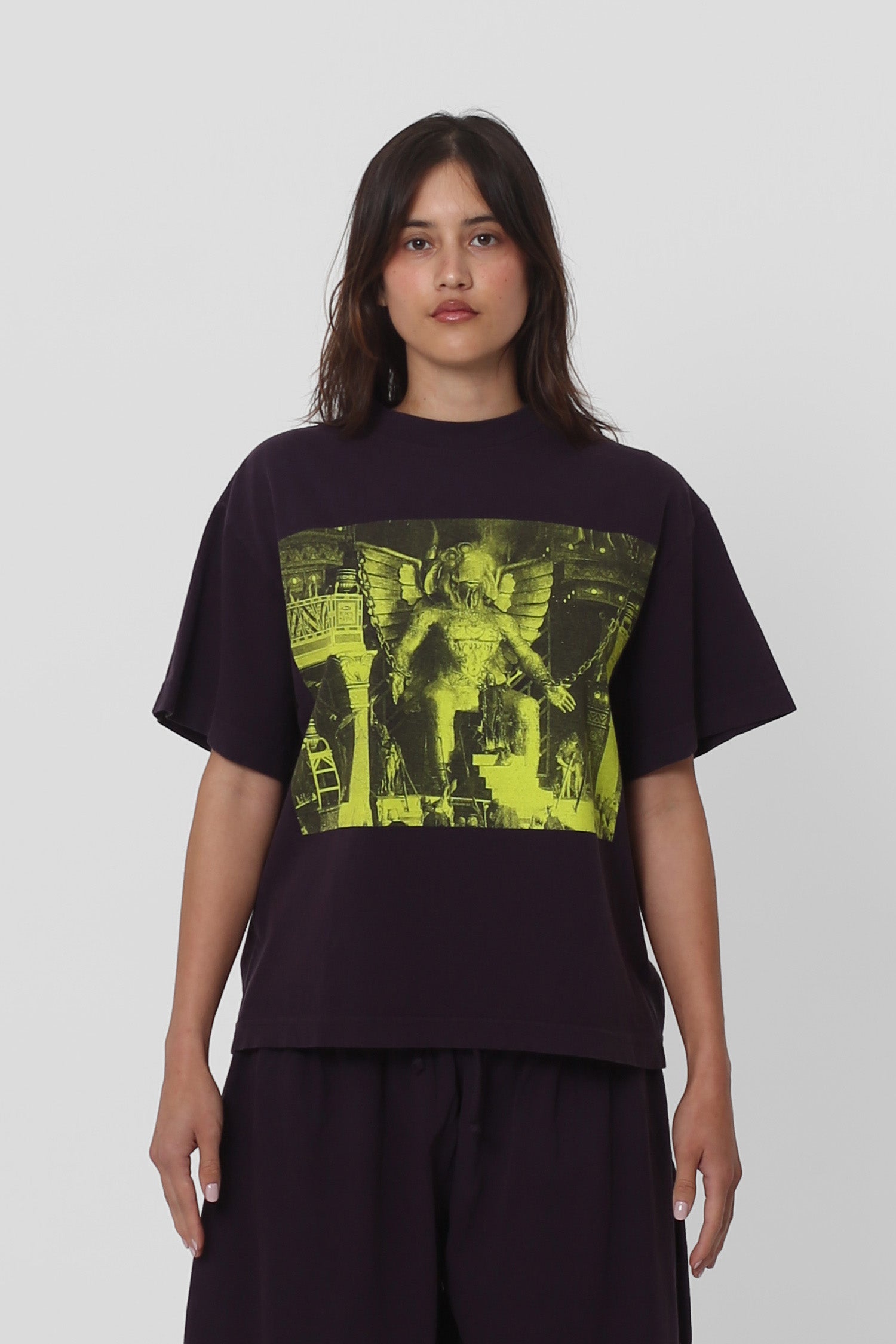 5'5" woman in a size S Mulberry Boxier Trash Tee. Hem at her middle hip.