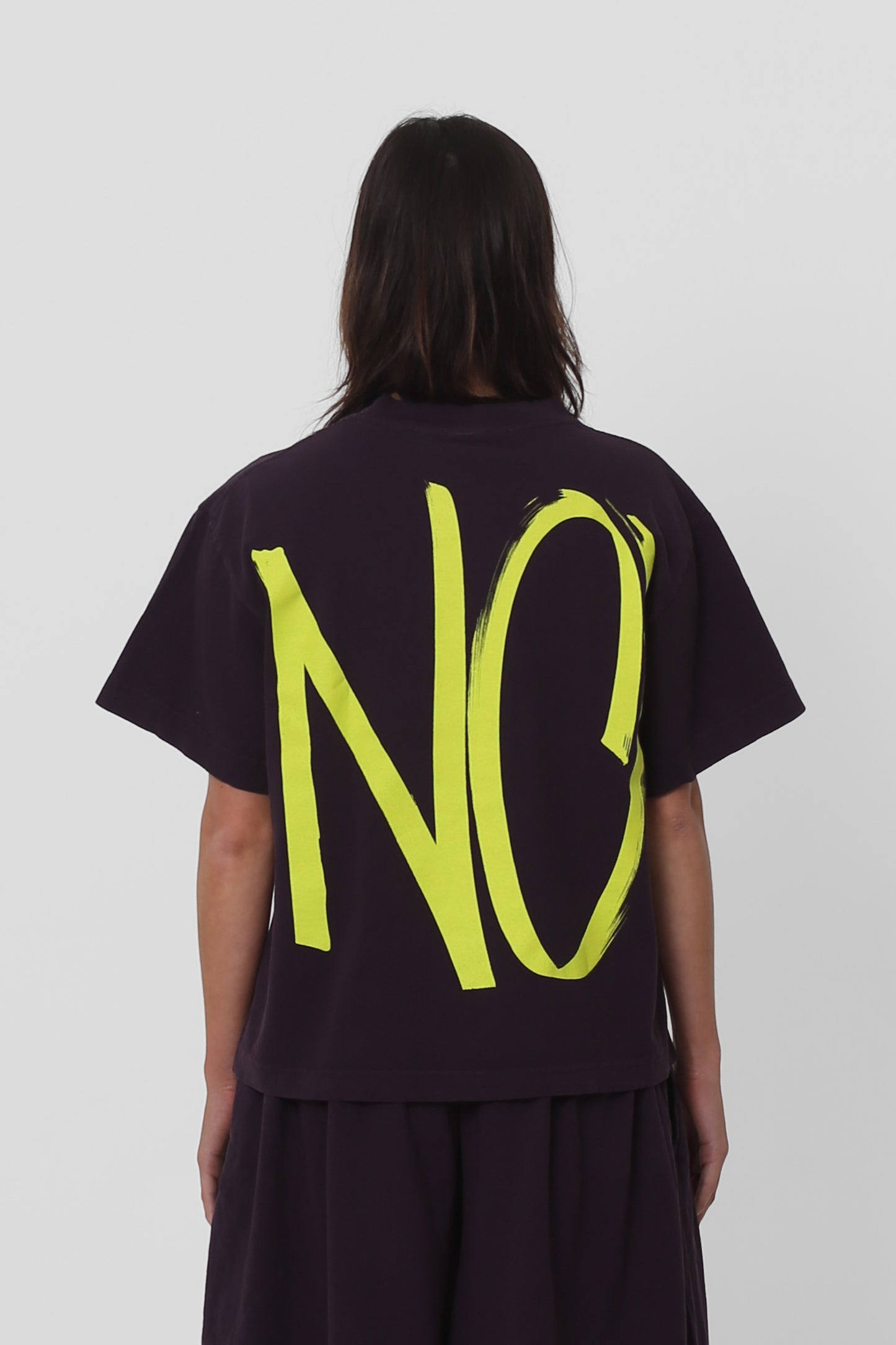 Back view showing the graphic, fabric drape and relaxed fit throughout.