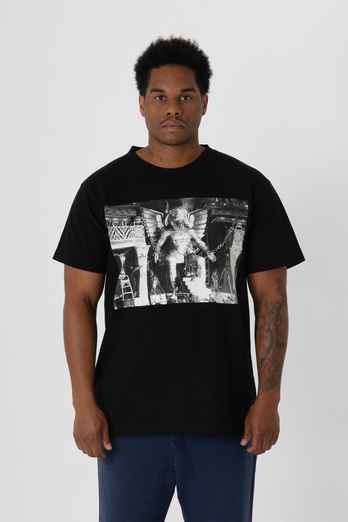 6' person in a size L Black Short Sleeve Trash Tee with a graphic. Hem hits just below the hip.