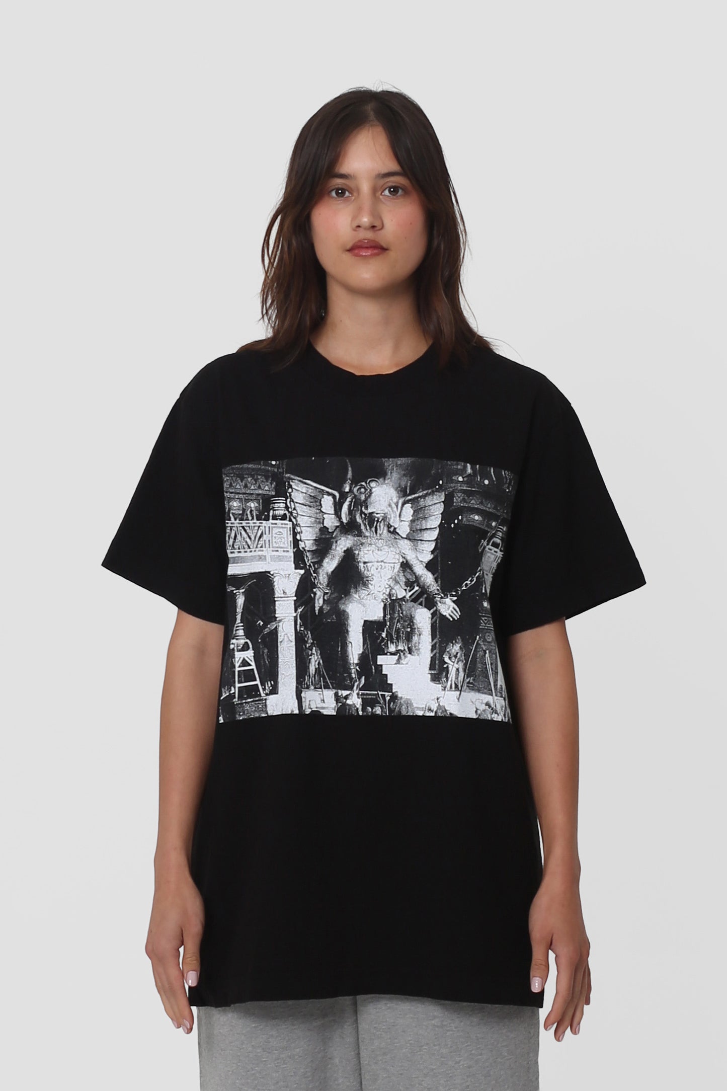 5'5" person in a size S Black Short Sleeve Trash Tee with a graphic. Hem hits just below the hip.